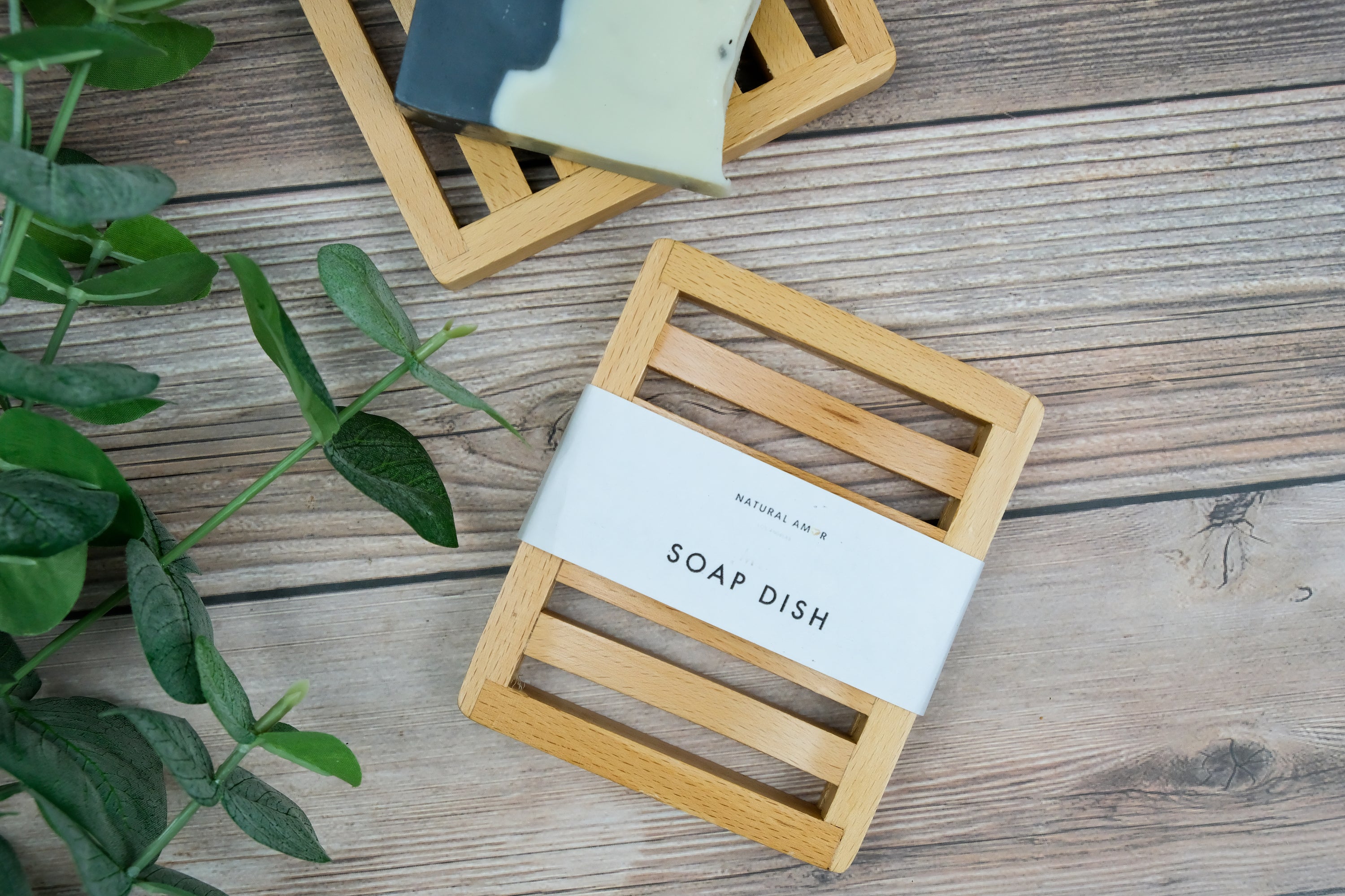 Natural wood soap dish designed to keep soap dry, featuring drainage holes and a sleek finish.