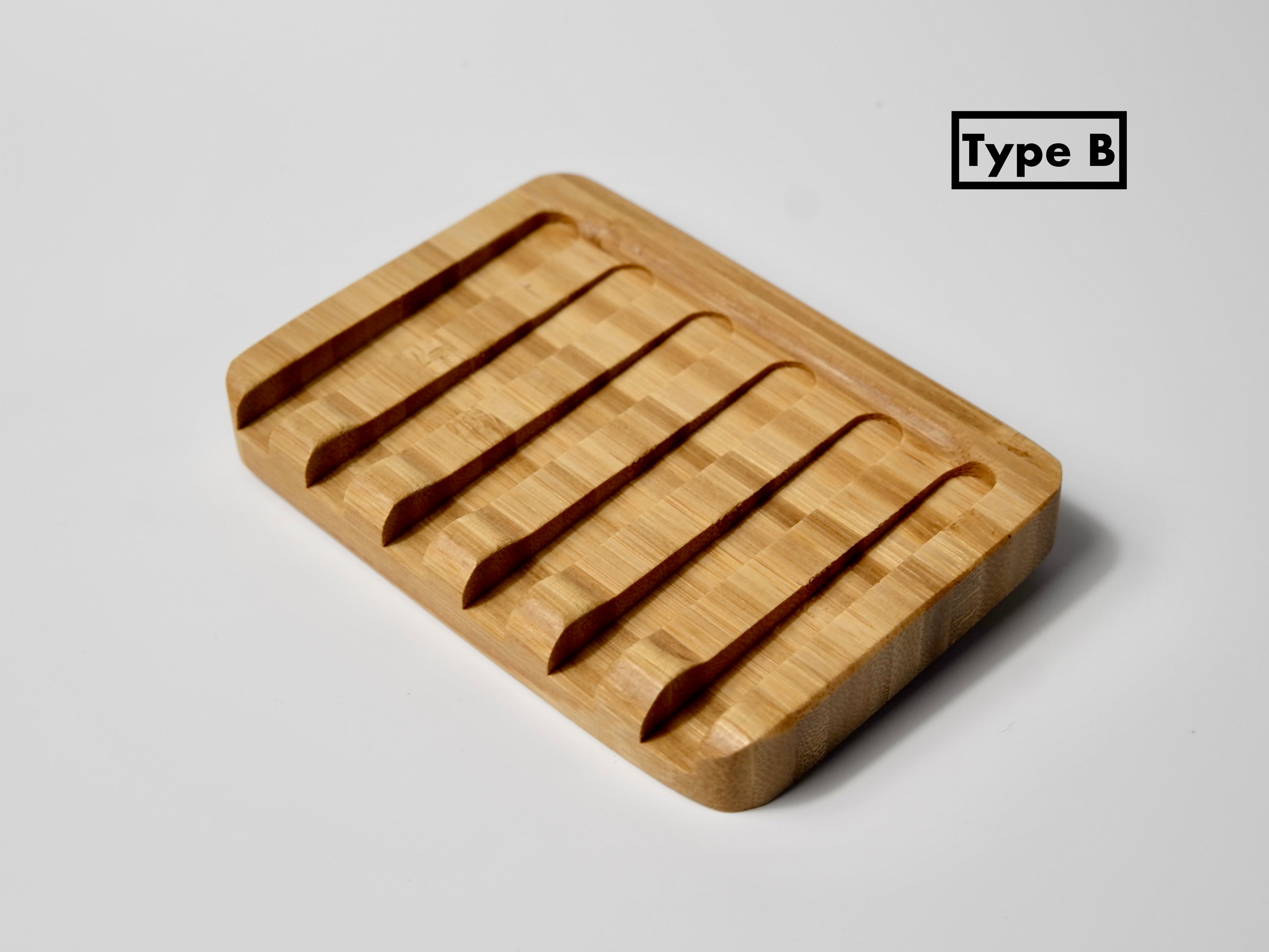 Natural wood soap dish designed to keep soap dry, featuring drainage holes and a sleek finish.
