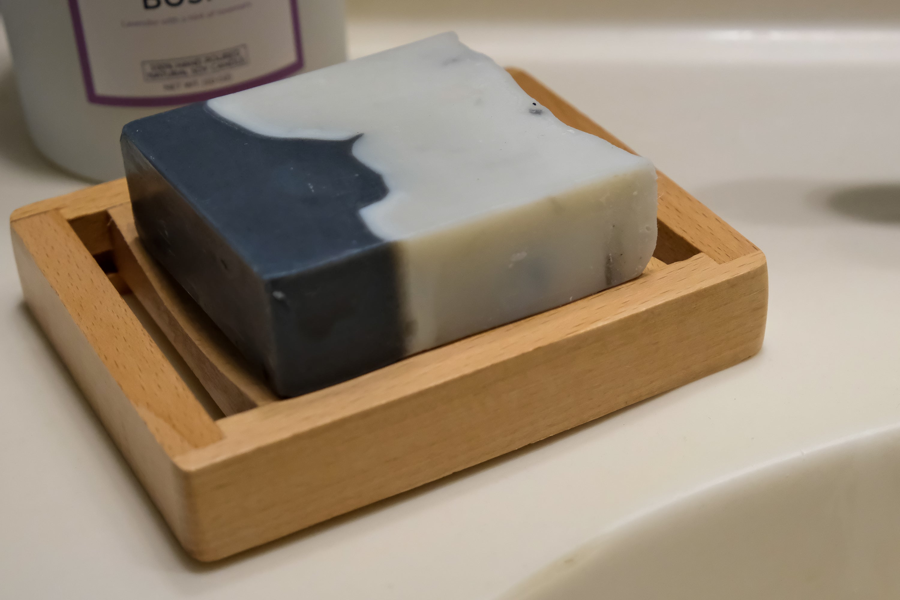 Natural wood soap dish designed to keep soap dry, featuring drainage holes and a sleek finish.
