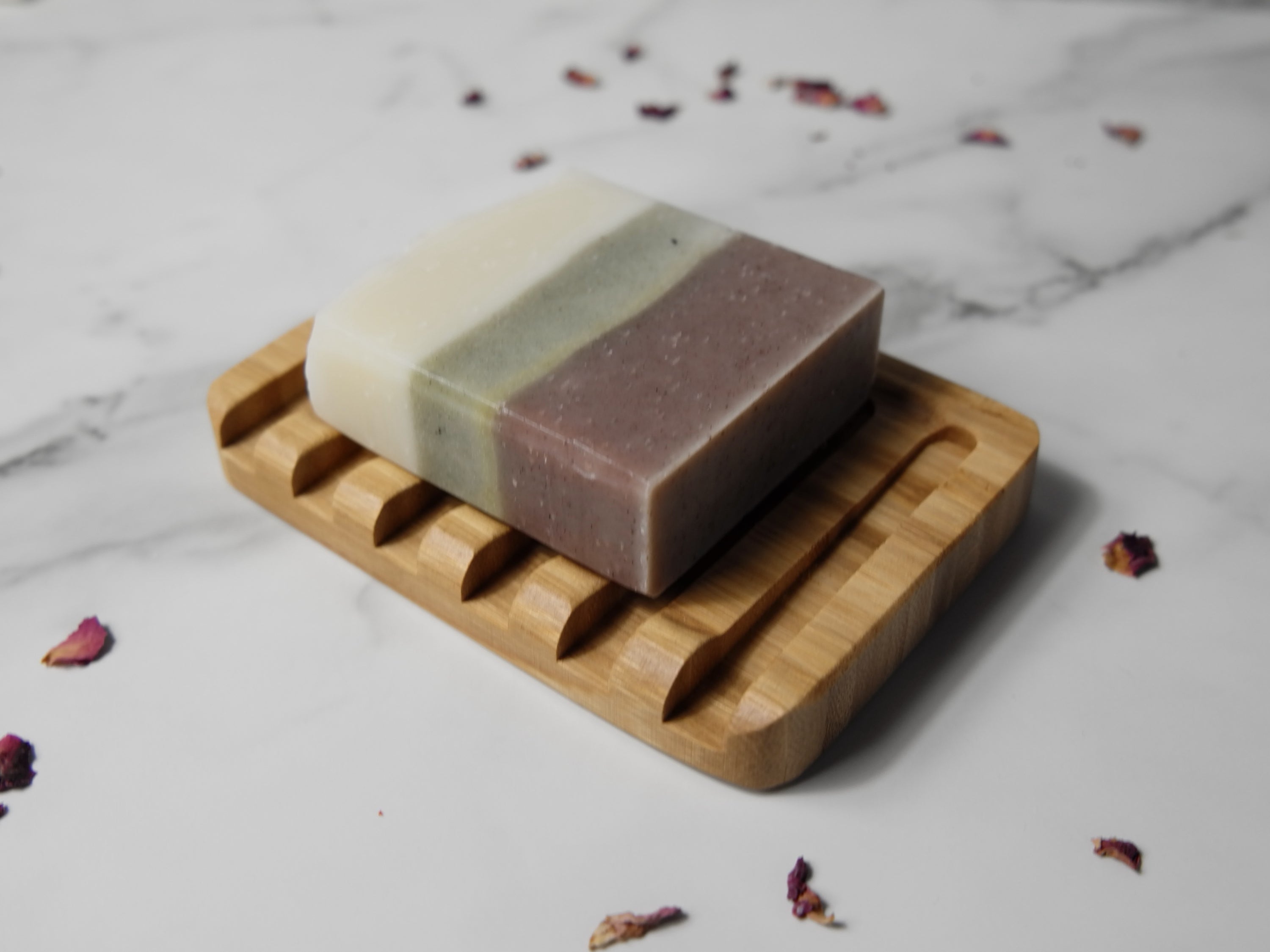Natural wood soap dish designed to keep soap dry, featuring drainage holes and a sleek finish.
