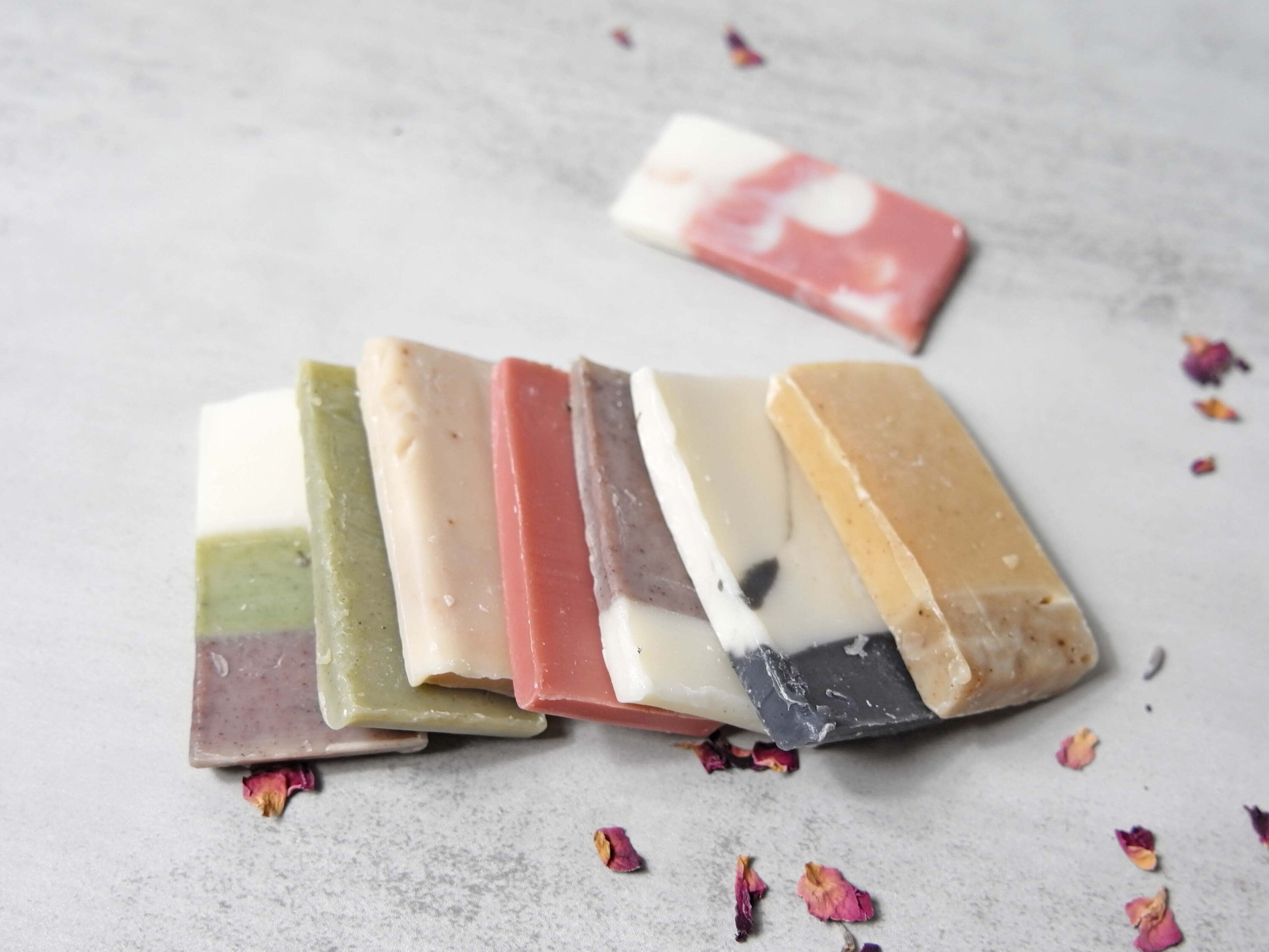 A collection of assorted soap samples in various scents, each approximately 0.5 oz, displayed attractively for potential buyers.