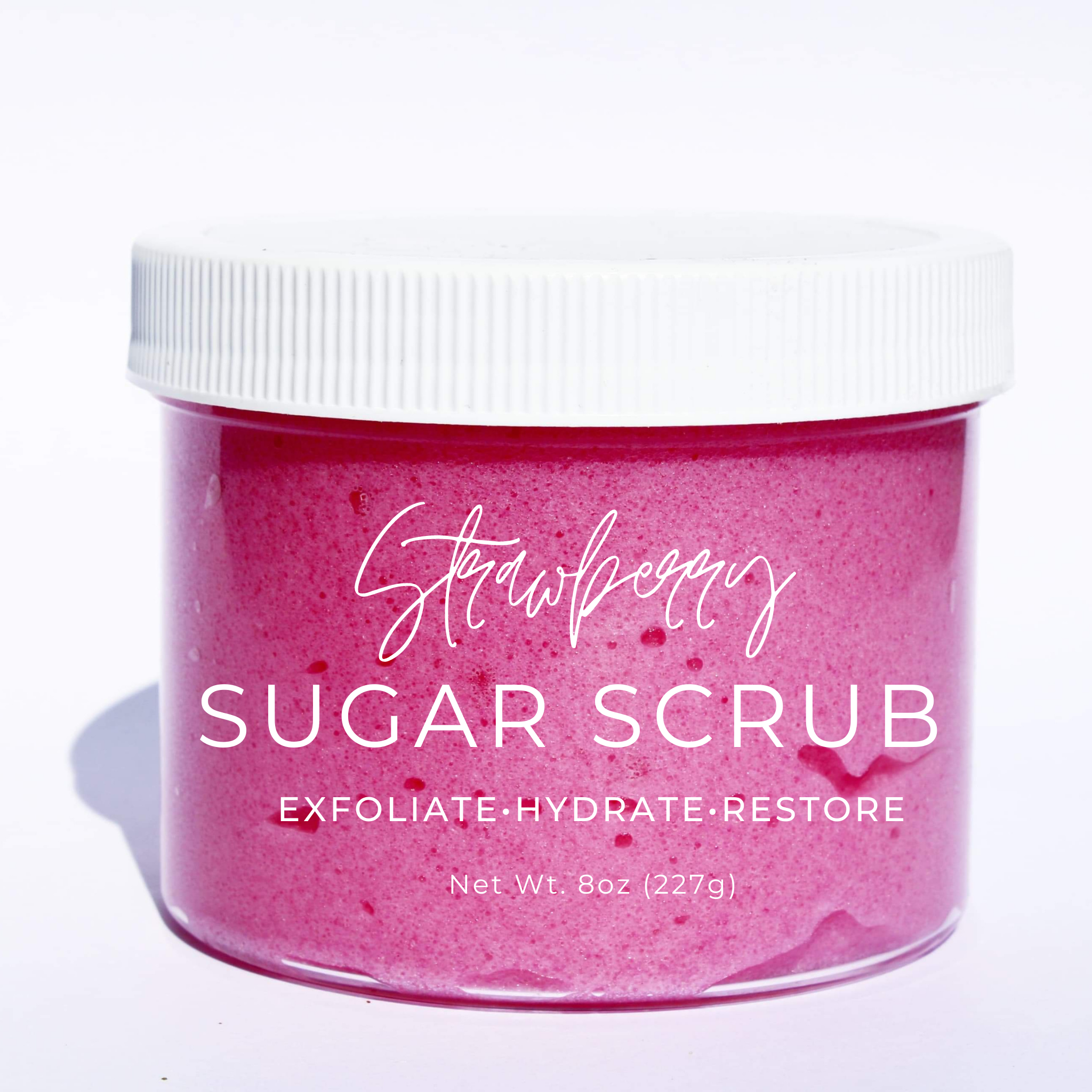 A jar of Strawberry Sugar Scrub with a creamy texture, surrounded by fresh strawberries and sugar granules, showcasing its natural ingredients.