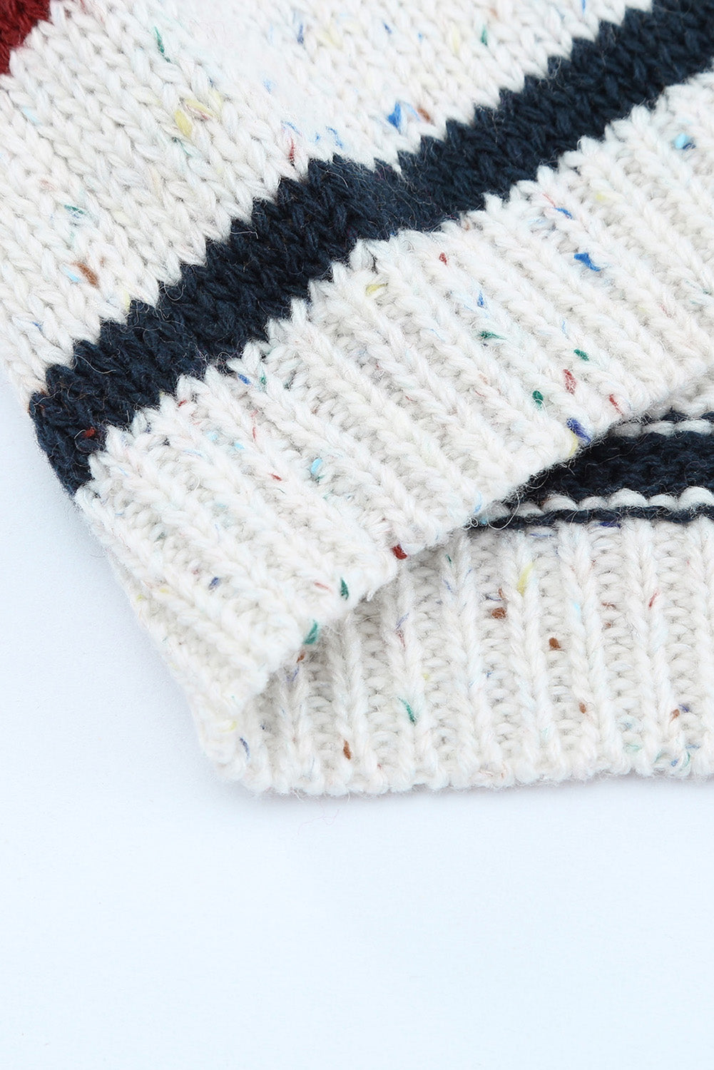 A stylish heathery grey knit sweater featuring colorful stripes, crew neck, and long drop sleeves, perfect for chilly weather.