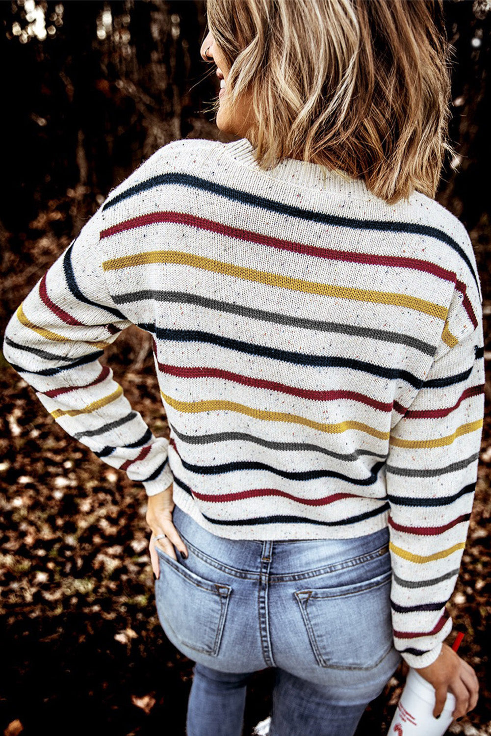 A stylish heathery grey knit sweater featuring colorful stripes, crew neck, and long drop sleeves, perfect for chilly weather.