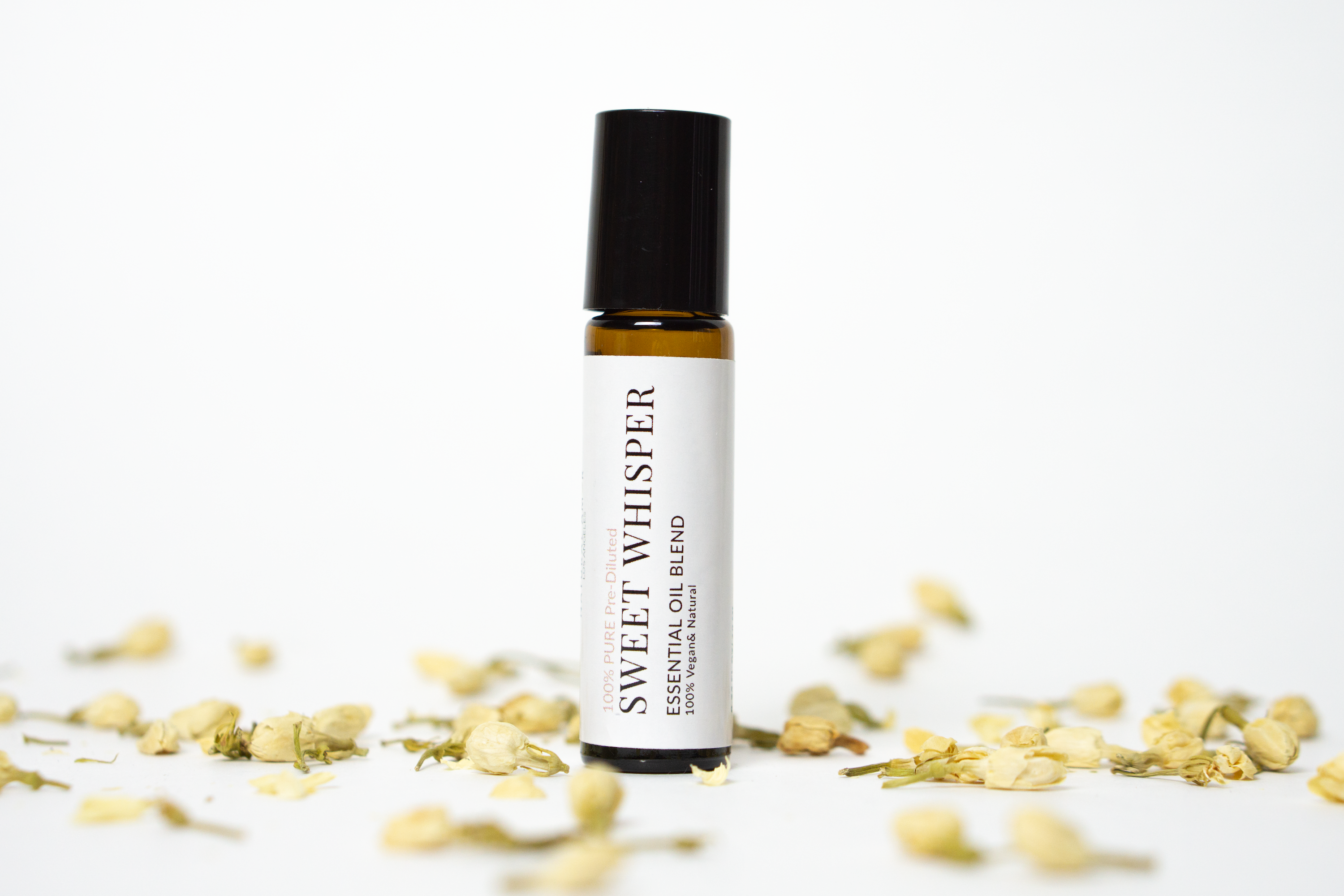 Sweet Whisper Roll On Essential Oil Blend in a 10 mL bottle with a stainless steel rollerball, featuring floral and warm essential oils.