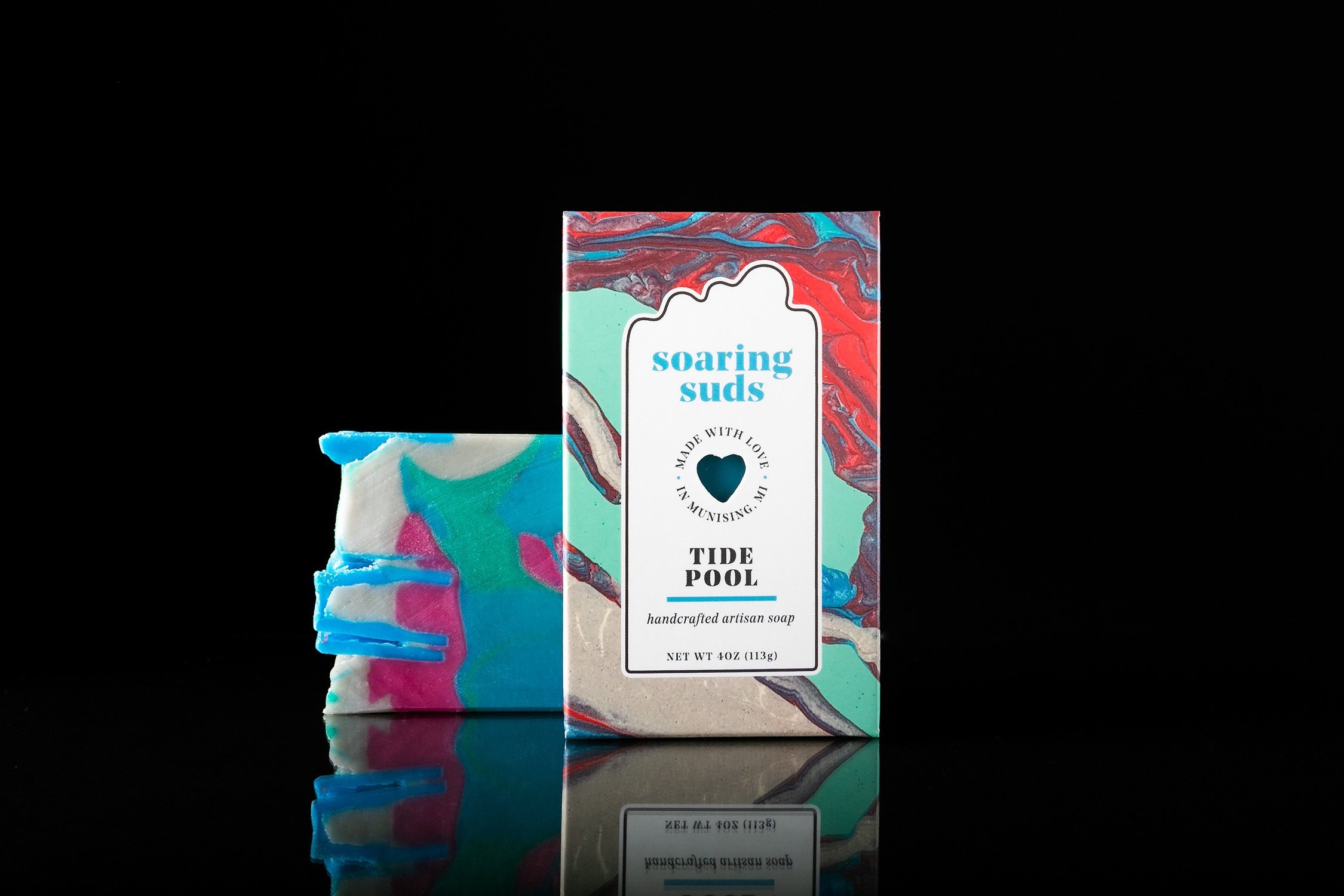 Tide Pool Artisan Soap bar with eucalyptus, sage, and spearmint, showcasing its unique handcrafted texture and vibrant colors.