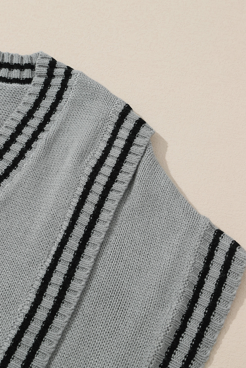 A stylish V Neck Contrast Stripes Trims Short Sleeve Sweater featuring a chic v-neckline, contrast stripe details, and soft knitted fabric.