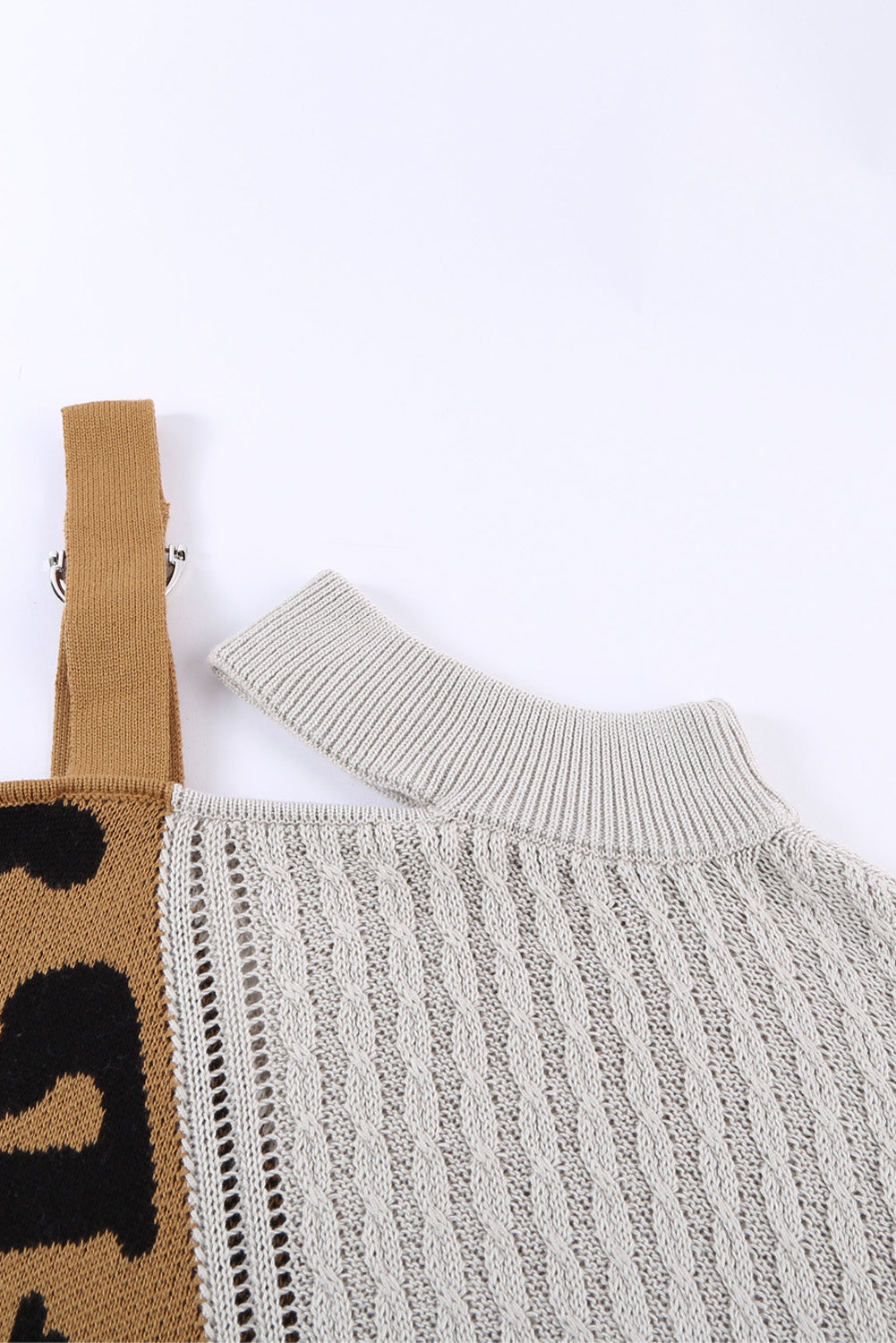 A stylish white asymmetrical sweater featuring a high neck, cold shoulder design, and buckle strap, perfect for chic outfits.