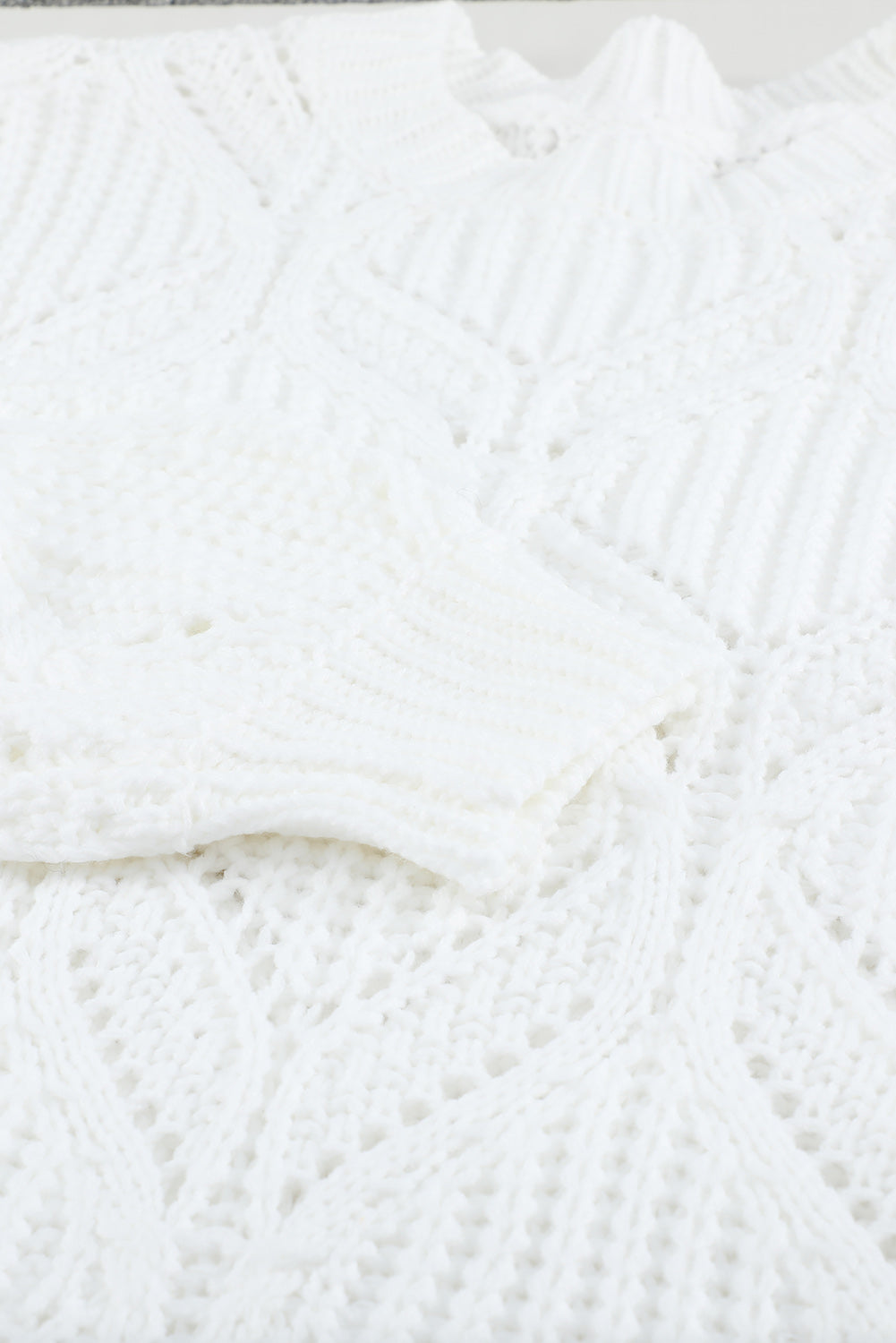 A stylish white crewneck sweater with balloon sleeves, featuring a textured knit design, perfect for casual wear.