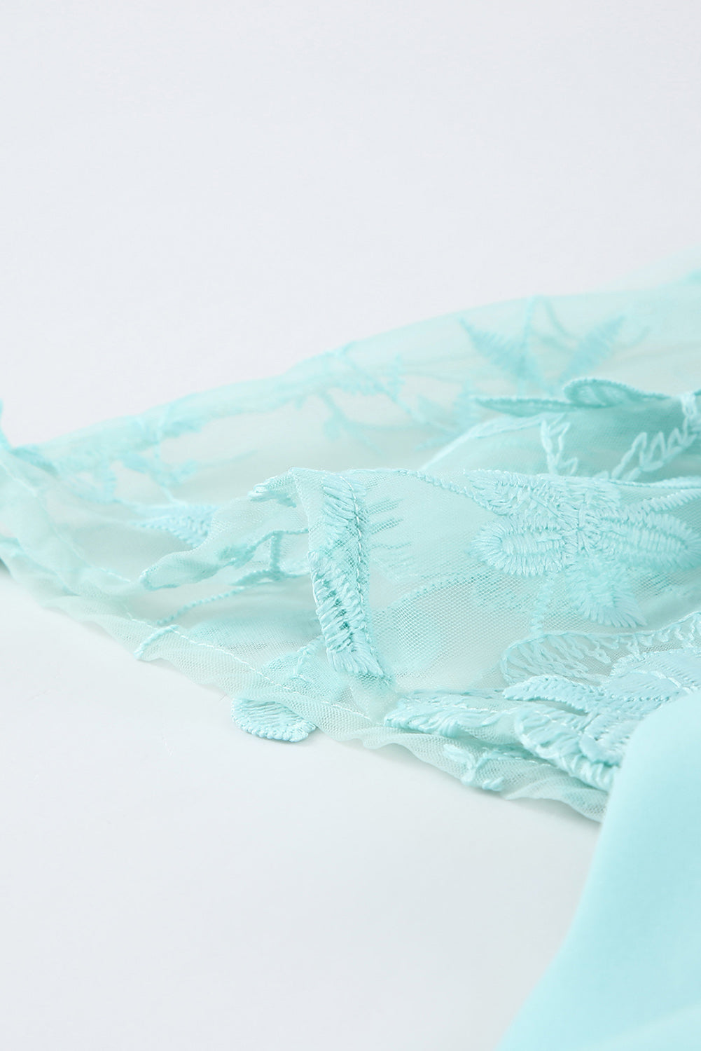 A beautiful white floral mesh lace crochet kimono with an open front, showcasing delicate lace details and a loose fit, perfect for summer wear.