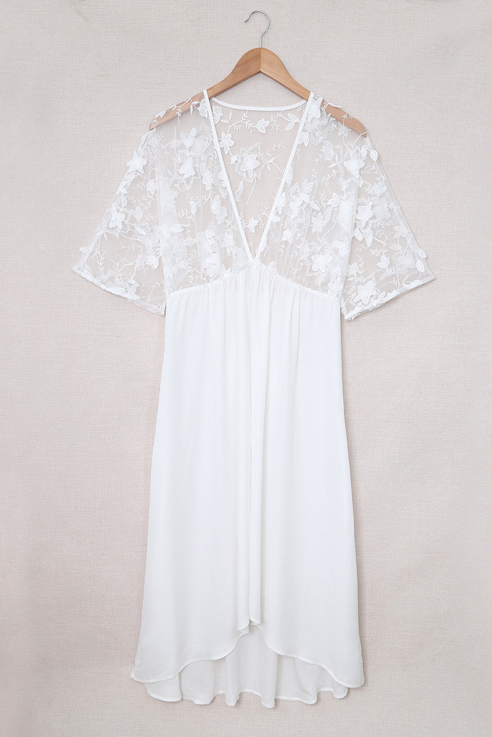 A beautiful white floral mesh lace crochet kimono with an open front, showcasing delicate lace details and a loose fit, perfect for summer wear.