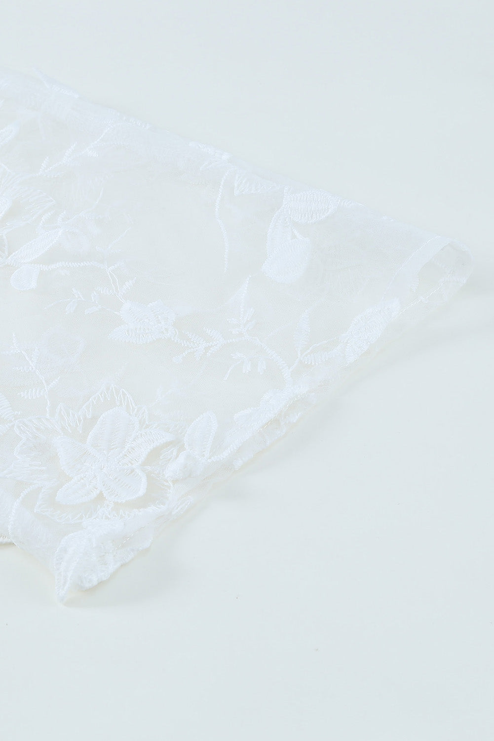 A beautiful white floral mesh lace crochet kimono with an open front, showcasing delicate lace details and a loose fit, perfect for summer wear.