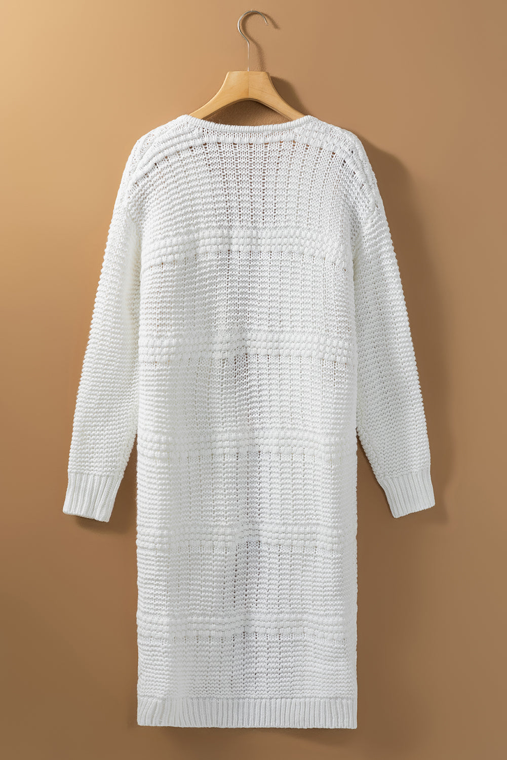 A stylish white long cardigan with fringed edges and open front, featuring two pockets, perfect for layering and adding elegance to any outfit.