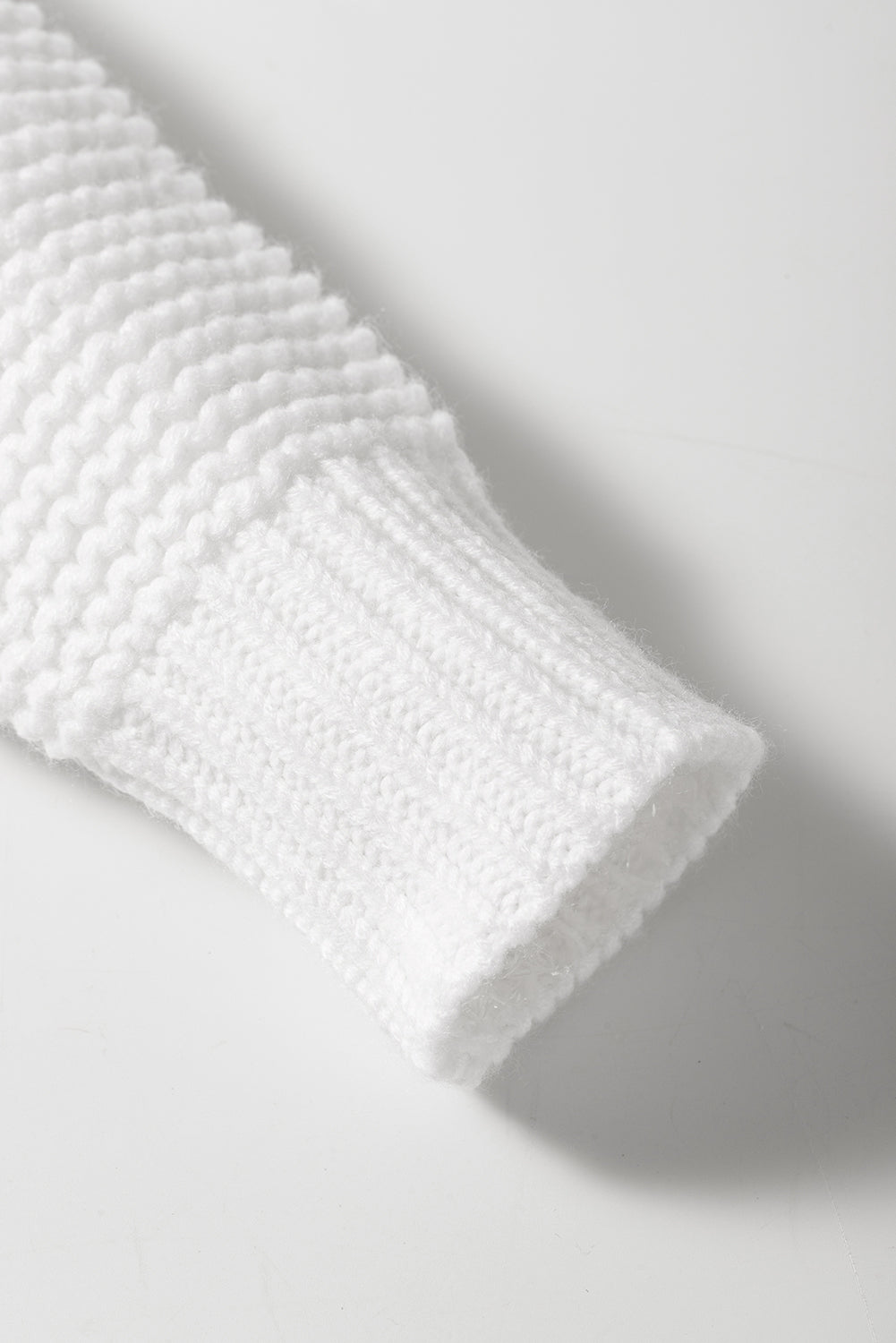 A stylish white long cardigan with fringed edges and open front, featuring two pockets, perfect for layering and adding elegance to any outfit.