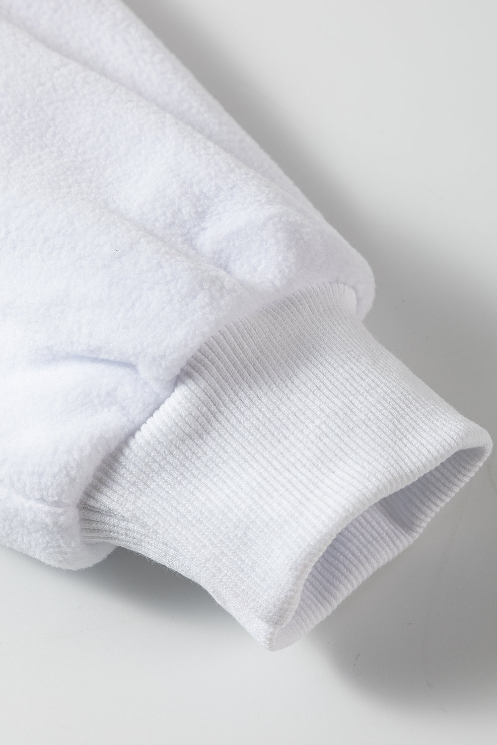 A cozy white baggy sweatshirt featuring the festive HOWDY SANTA graphic in chenille letters, perfect for holiday celebrations.