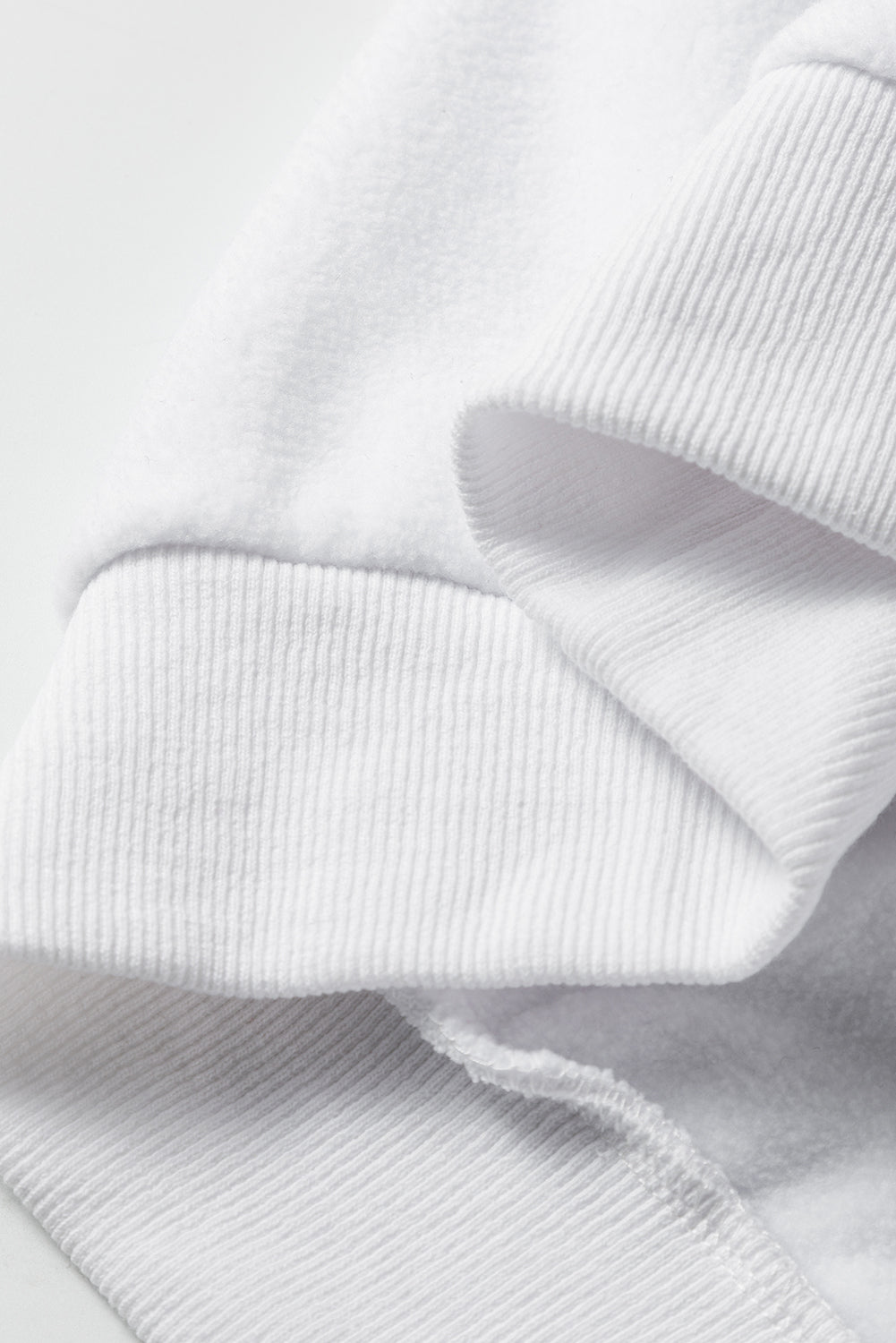 A cozy white baggy sweatshirt featuring the festive HOWDY SANTA graphic in chenille letters, perfect for holiday celebrations.