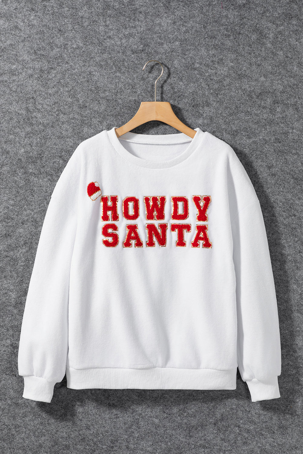 A cozy white baggy sweatshirt featuring the festive HOWDY SANTA graphic in chenille letters, perfect for holiday celebrations.
