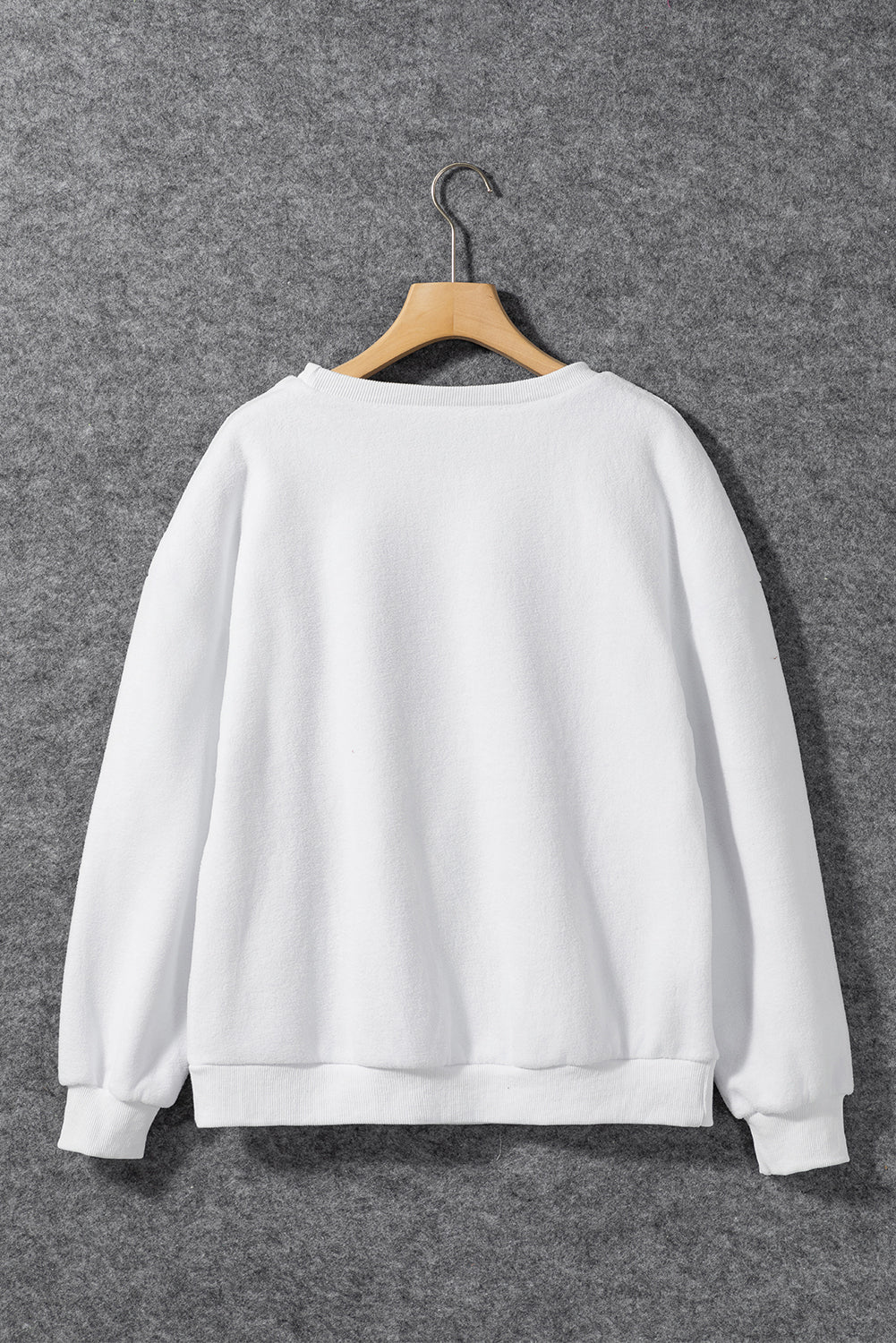 A cozy white baggy sweatshirt featuring the festive HOWDY SANTA graphic in chenille letters, perfect for holiday celebrations.