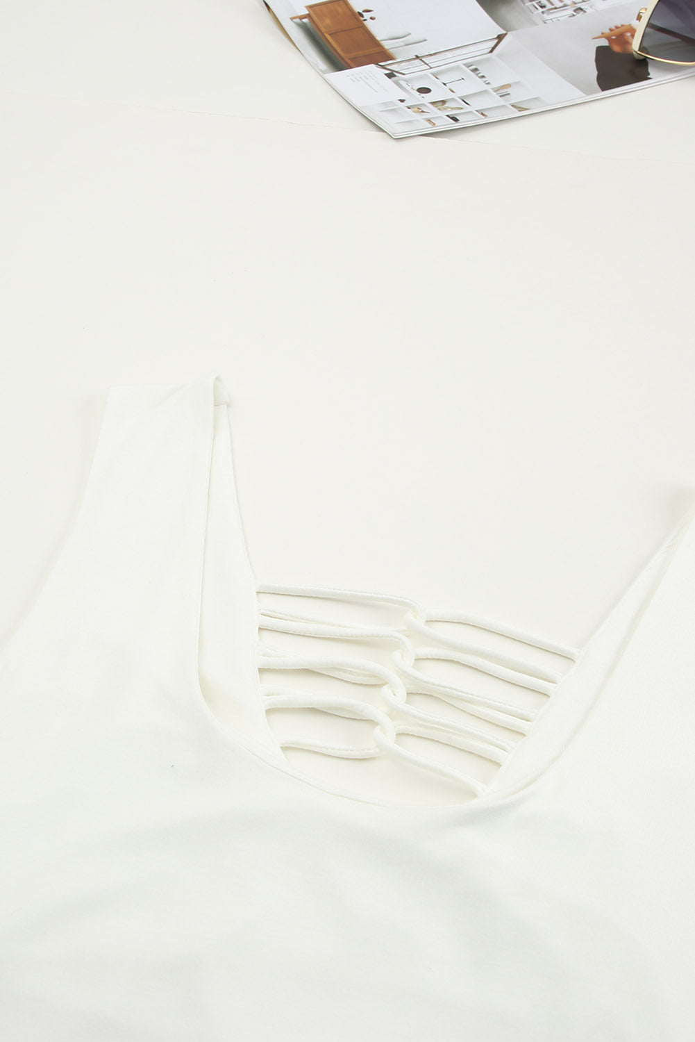 White lace-up hollow-out neck solid tank top showcasing a stylish design with a deep U-neck and sleeveless cut.