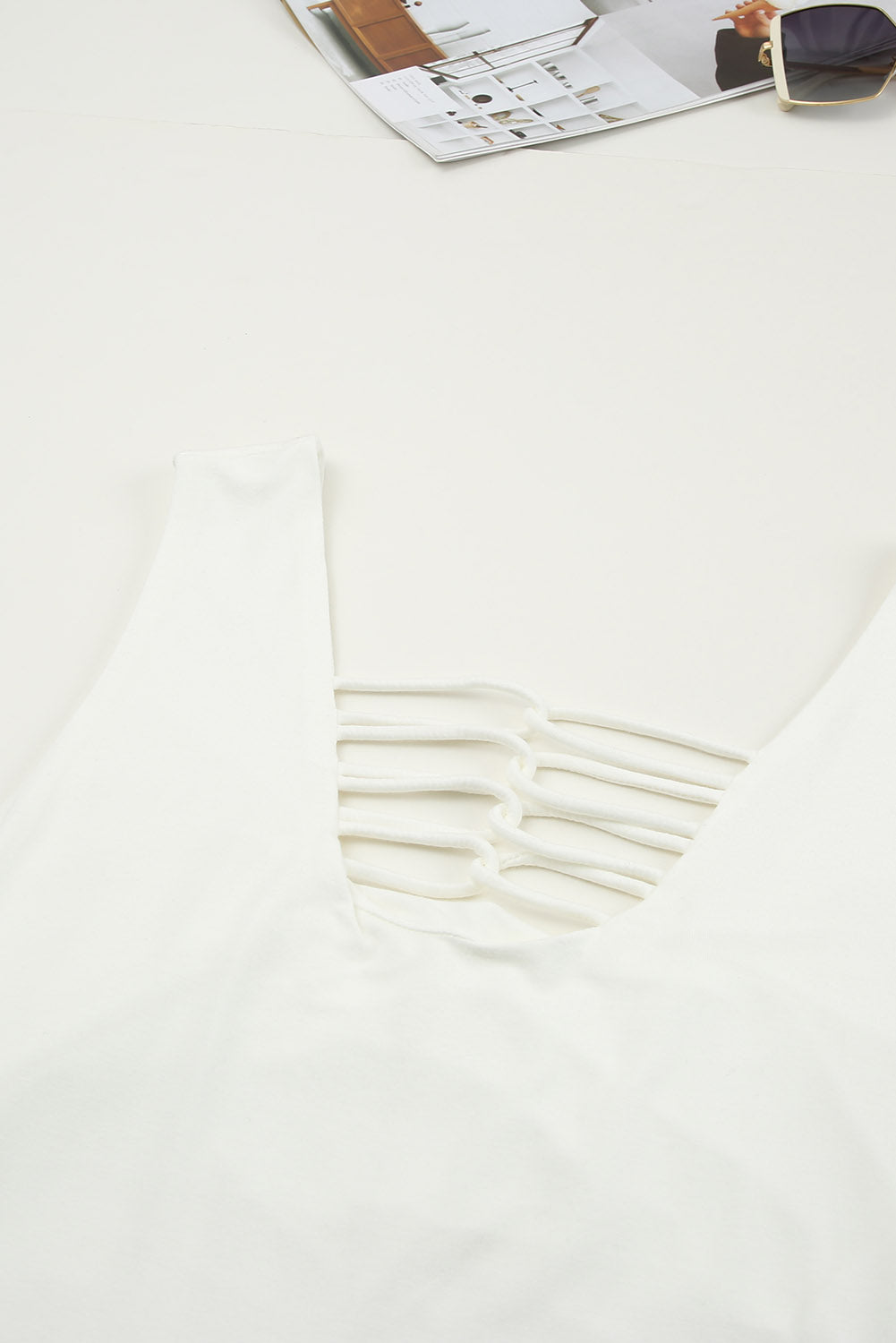 White lace-up hollow-out neck solid tank top showcasing a stylish design with a deep U-neck and sleeveless cut.
