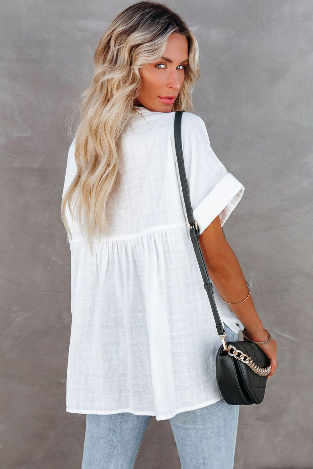 A stylish white plaid print loose V neck short sleeve shirt with slits, showcasing its trendy design and comfortable fit.