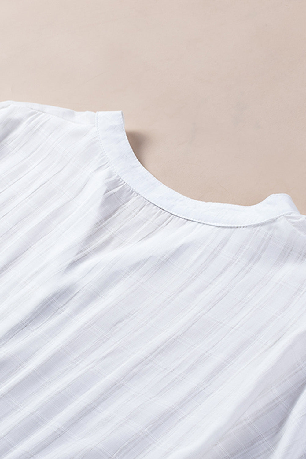 A stylish white plaid print loose V neck short sleeve shirt with slits, showcasing its trendy design and comfortable fit.