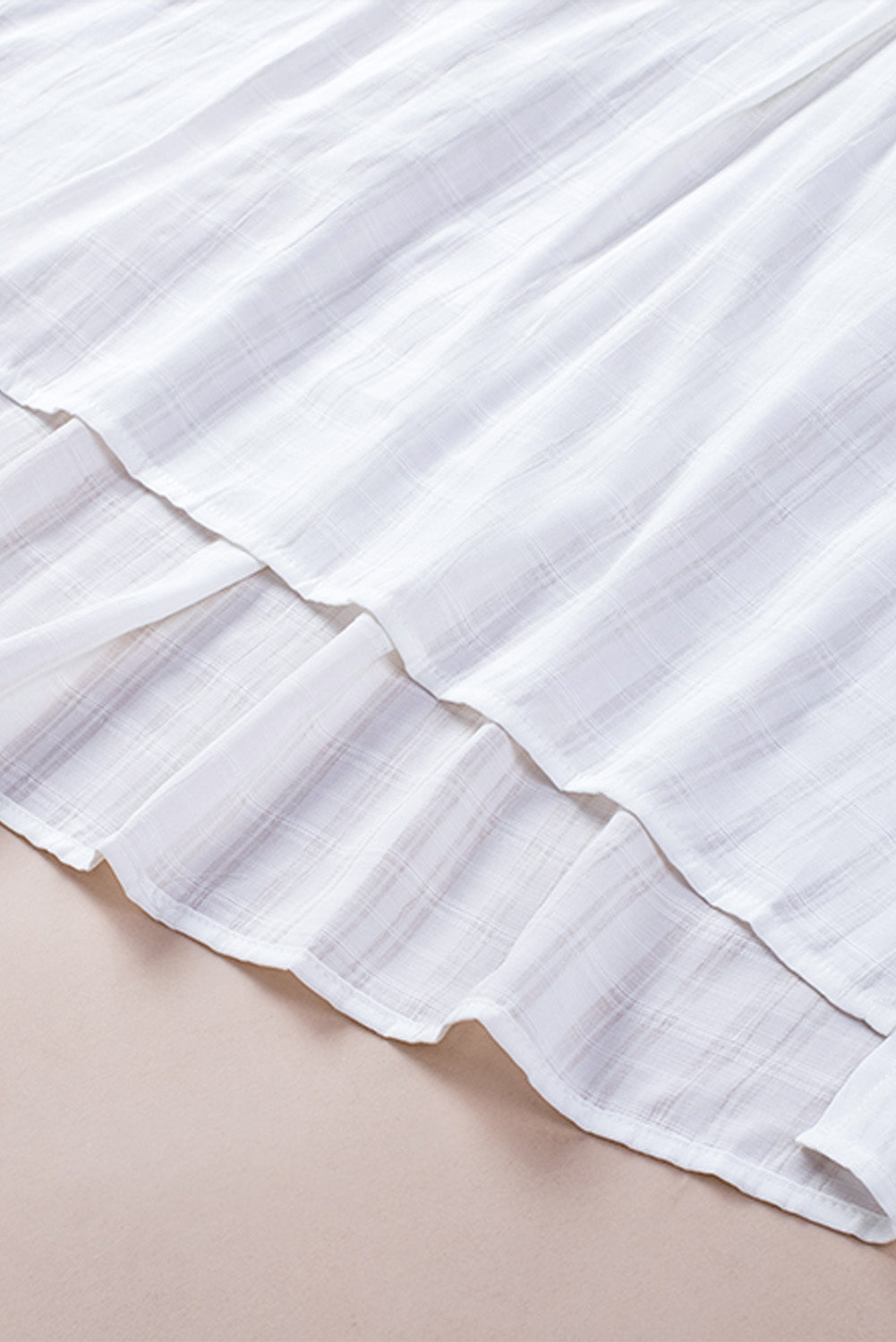 A stylish white plaid print loose V neck short sleeve shirt with slits, showcasing its trendy design and comfortable fit.