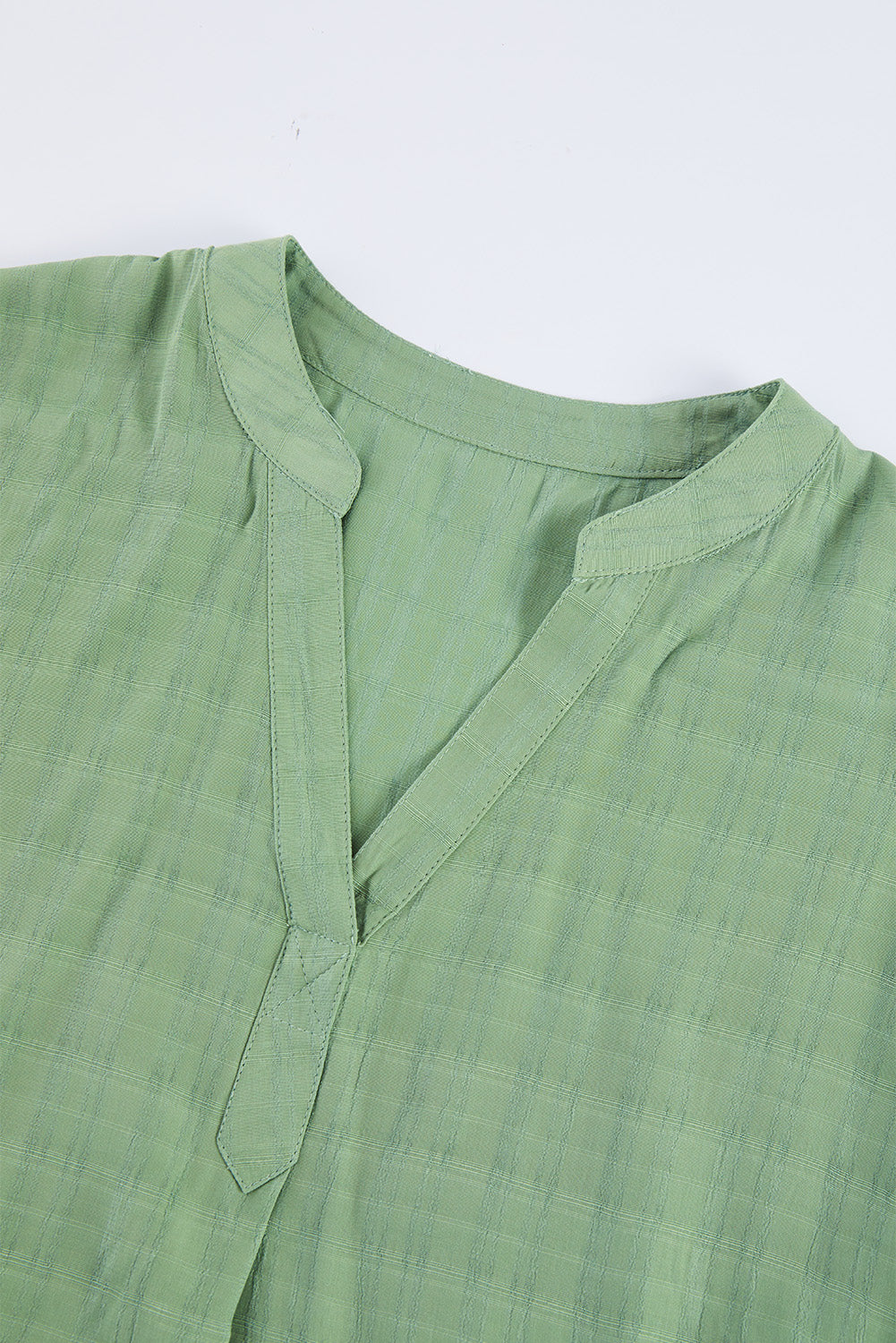 A stylish white plaid print loose V neck short sleeve shirt with slits, showcasing its trendy design and comfortable fit.