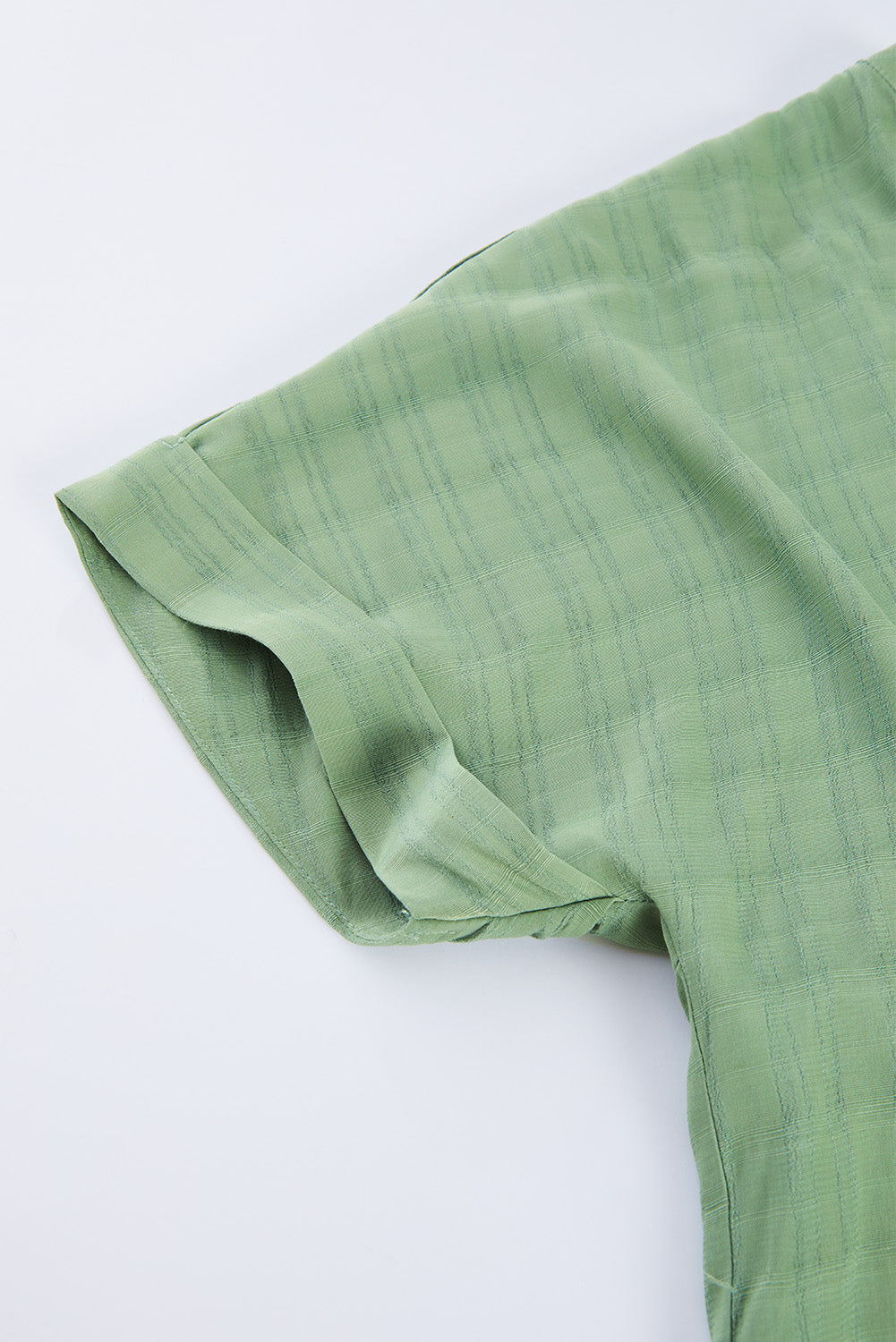 A stylish white plaid print loose V neck short sleeve shirt with slits, showcasing its trendy design and comfortable fit.