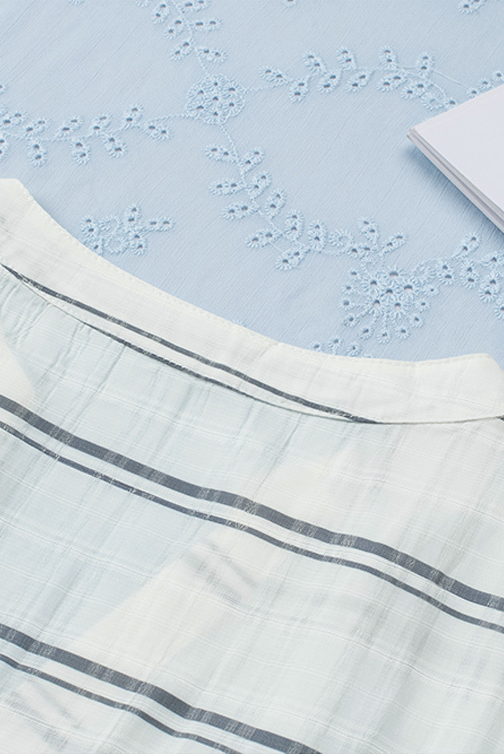 A stylish white plaid print loose V neck short sleeve shirt with slits, showcasing its trendy design and comfortable fit.