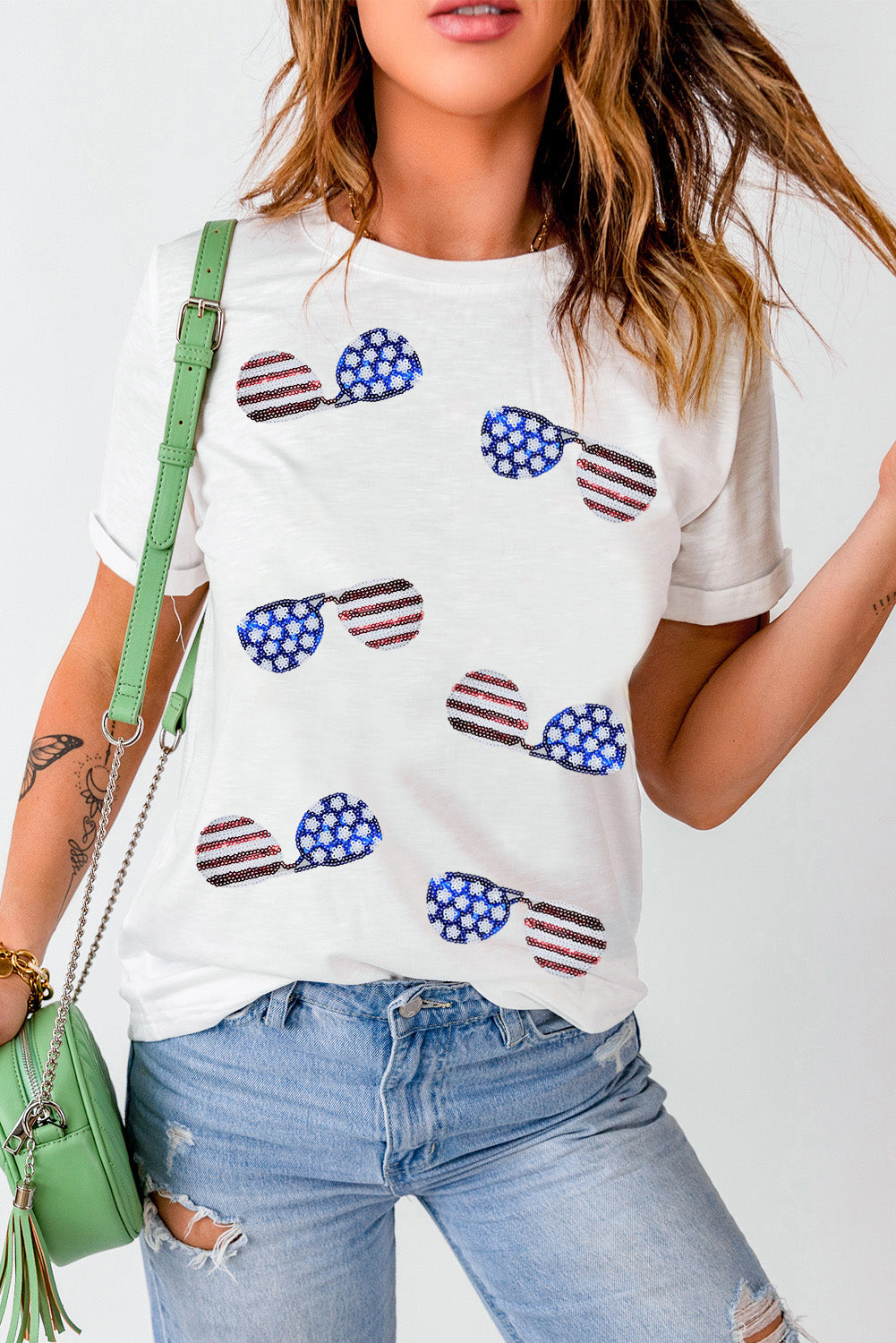White crew neck t-shirt featuring a sequined American flag design with sunglasses, perfect for casual wear.