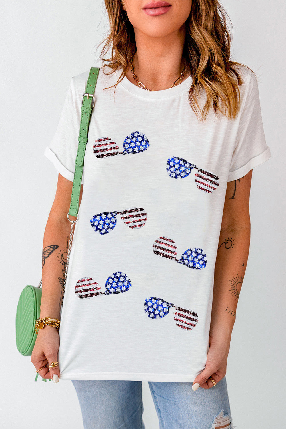 White crew neck t-shirt featuring a sequined American flag design with sunglasses, perfect for casual wear.