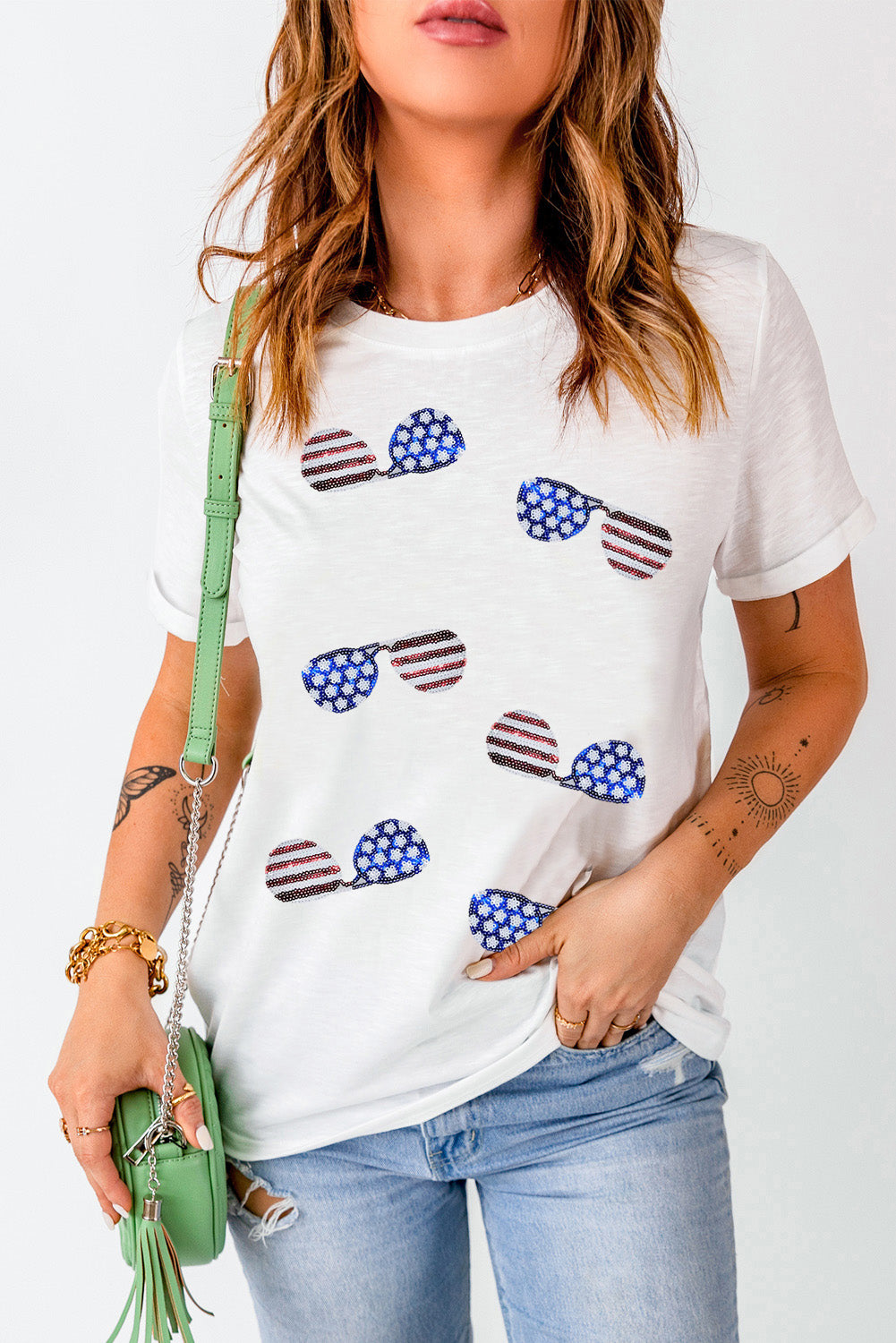 White crew neck t-shirt featuring a sequined American flag design with sunglasses, perfect for casual wear.