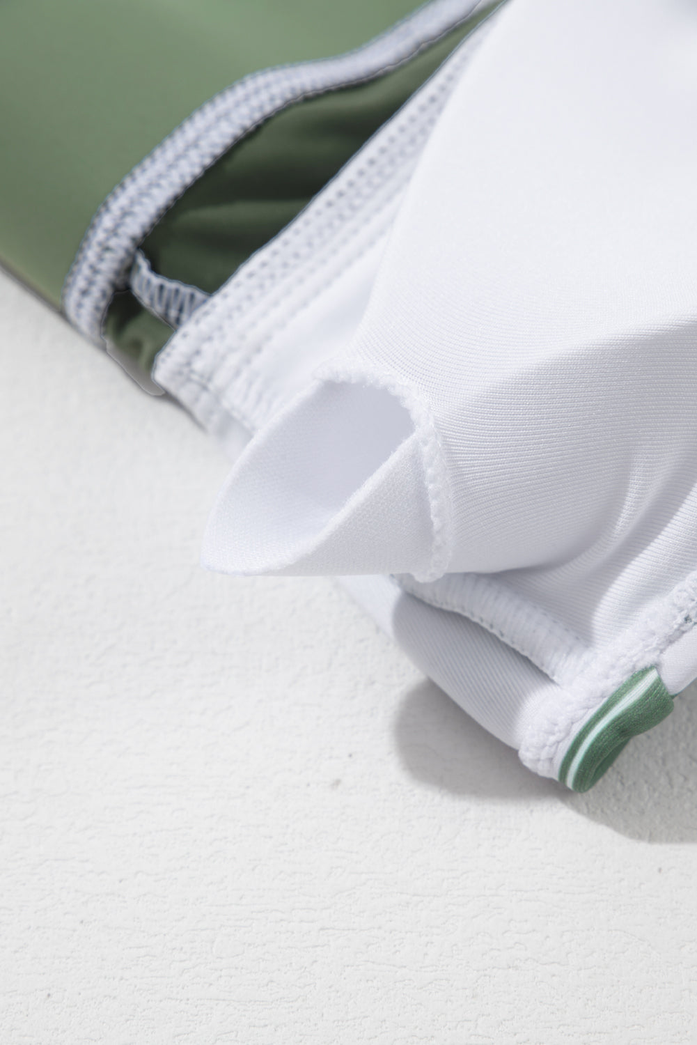 White Stripe Zipped Cut Out Racer Back High Waisted Bikini displayed on a mannequin, showcasing its stylish design and high-waisted fit.