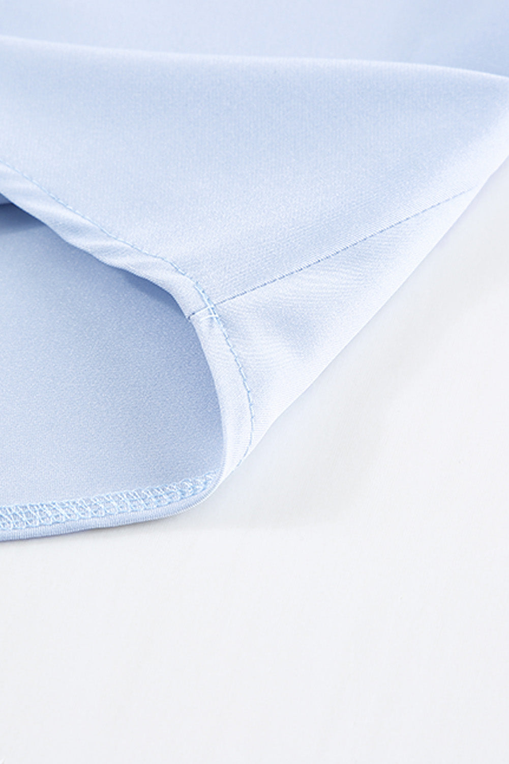 A stylish white V neck t-shirt featuring a delicate lace trim, showcasing its relaxed fit and elegant design.