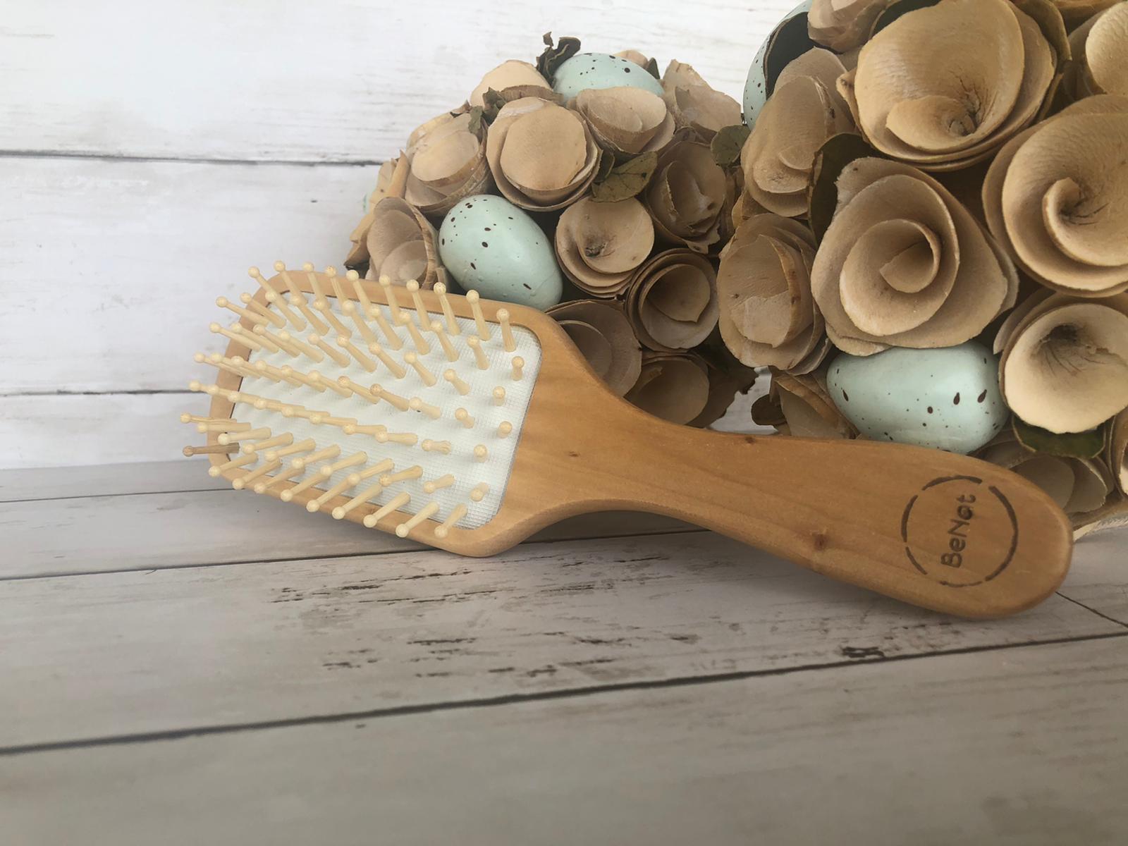 Wooden Detangling Hair Brush with bamboo bristles and natural rubber cushioning, designed for smooth and healthy hair.