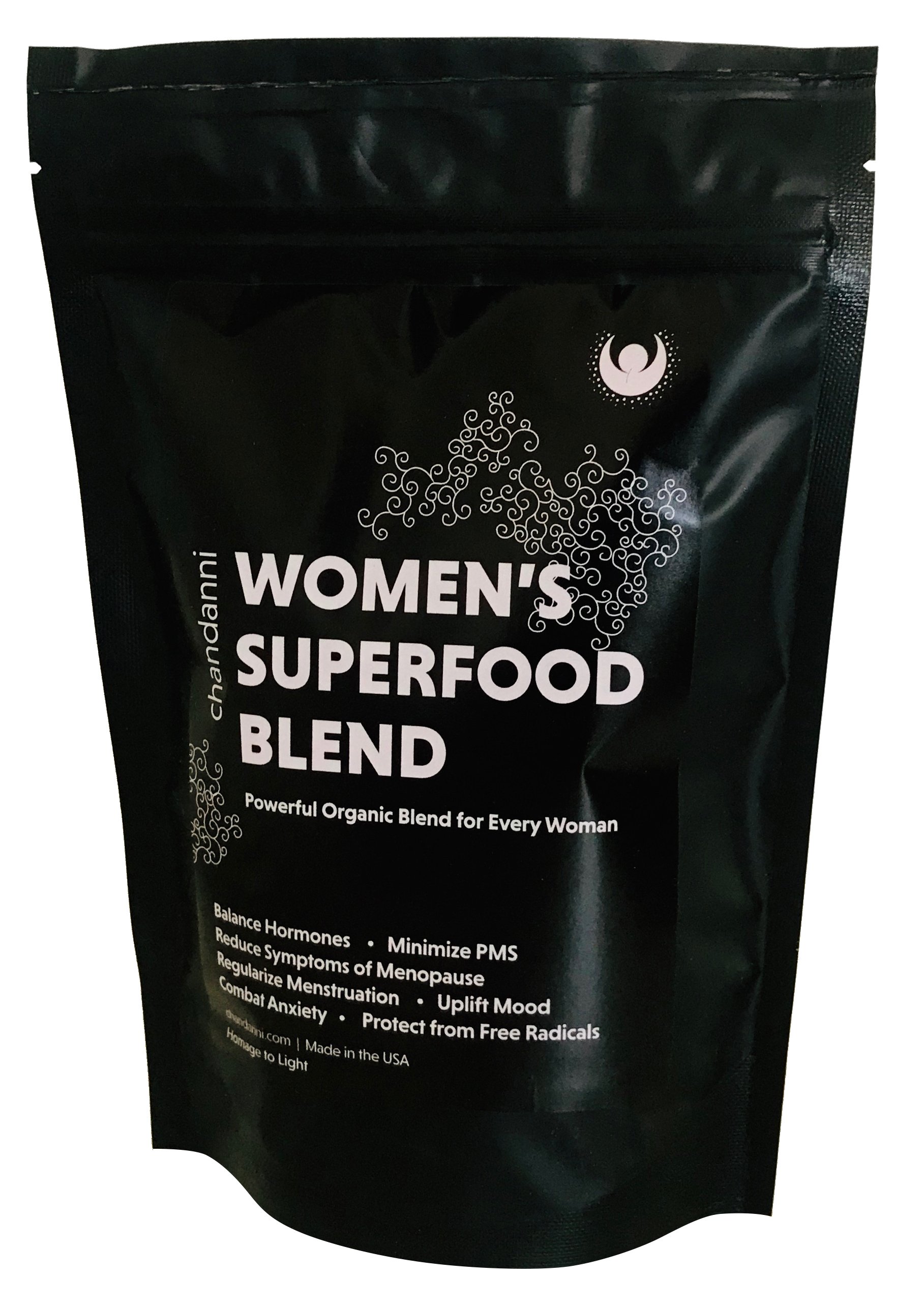 Chandanni's Organic Women's Superfood Blend in a stylish container, surrounded by fresh ingredients like cacao and herbs, showcasing its natural and healthy essence.