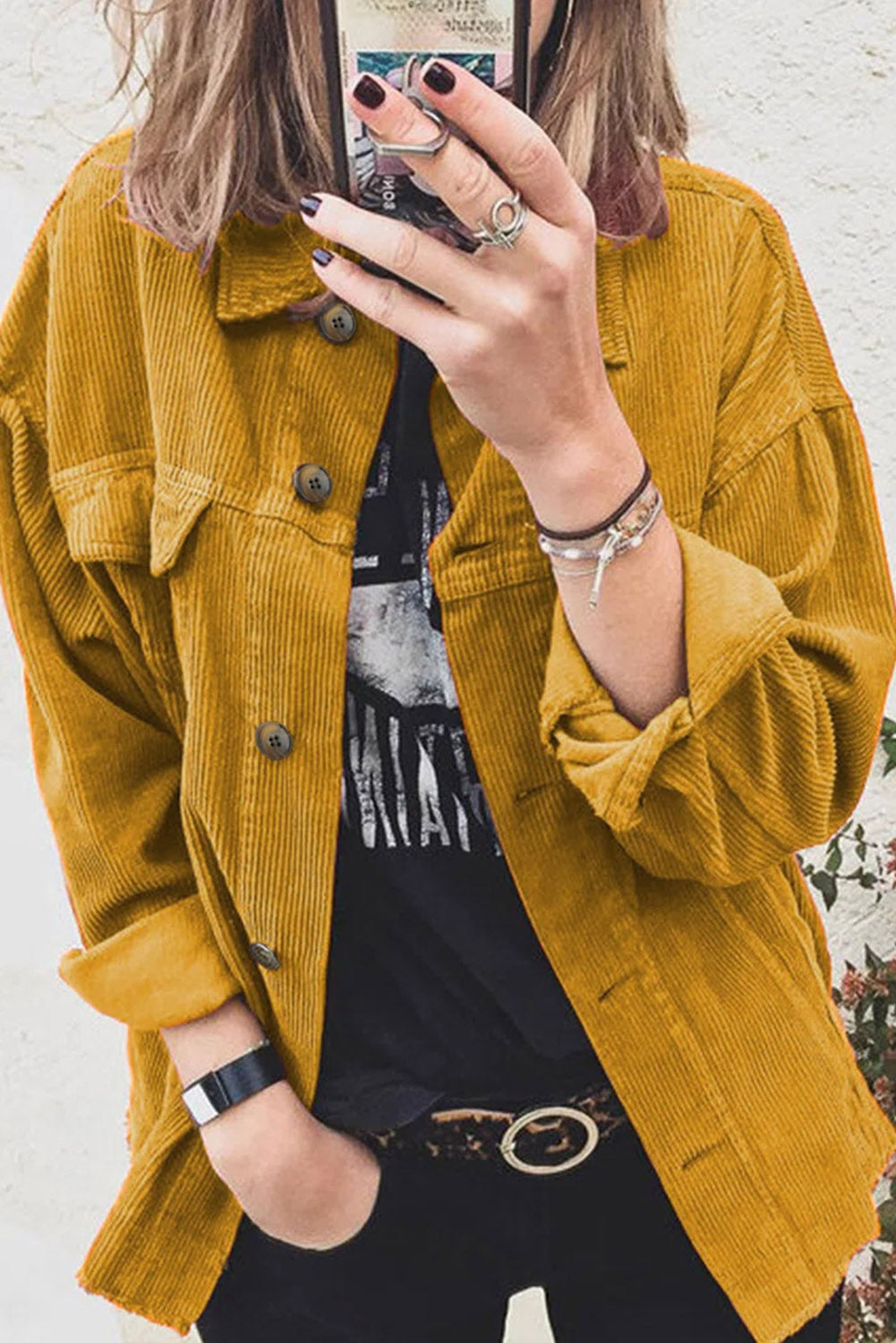 A stylish yellow corduroy long sleeve button-up shirt coat displayed on a hanger, showcasing its casual and fashionable design.