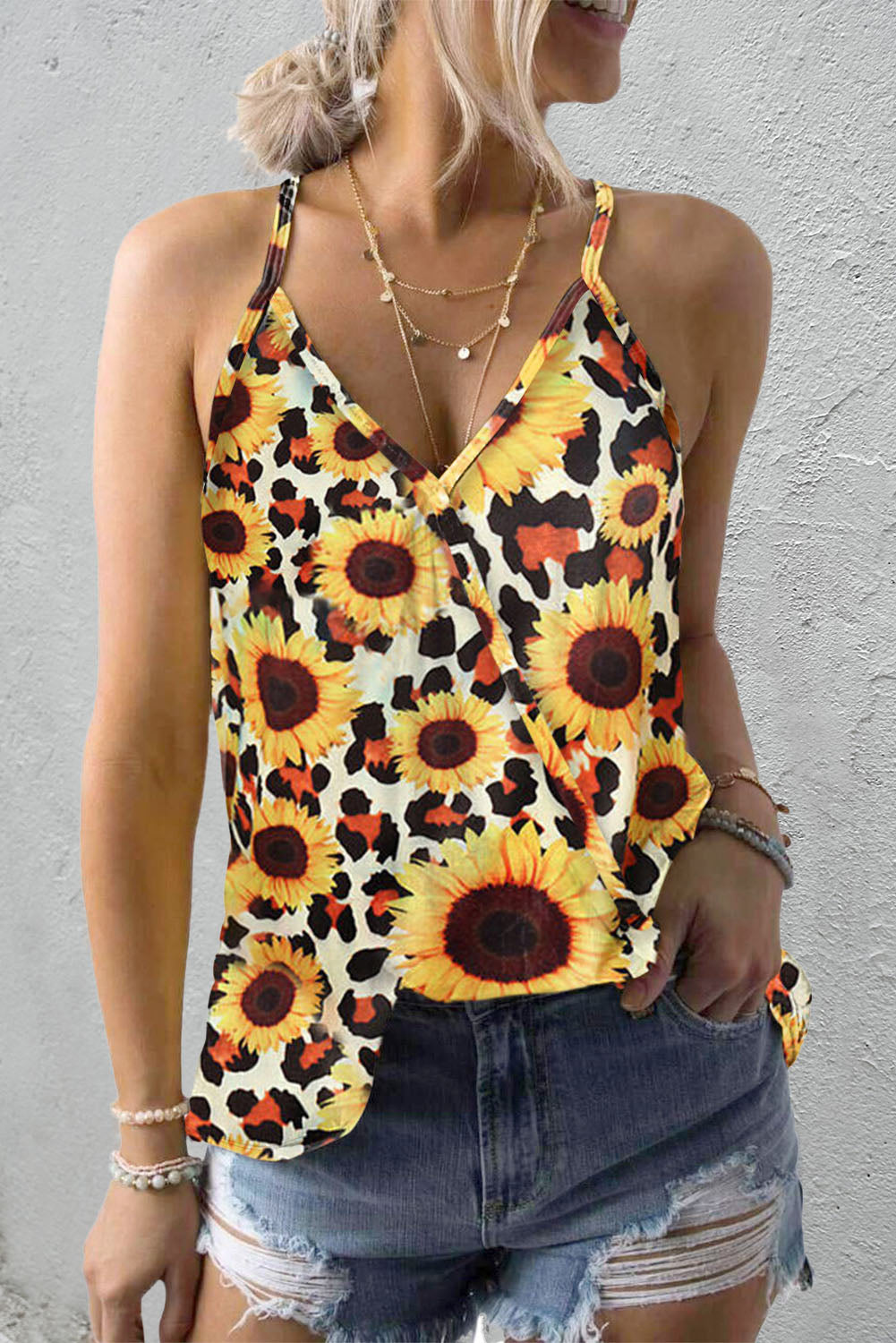 A vibrant yellow tank top featuring a sunflower print, designed with a v-neckline and sleeveless style, perfect for summer wear.