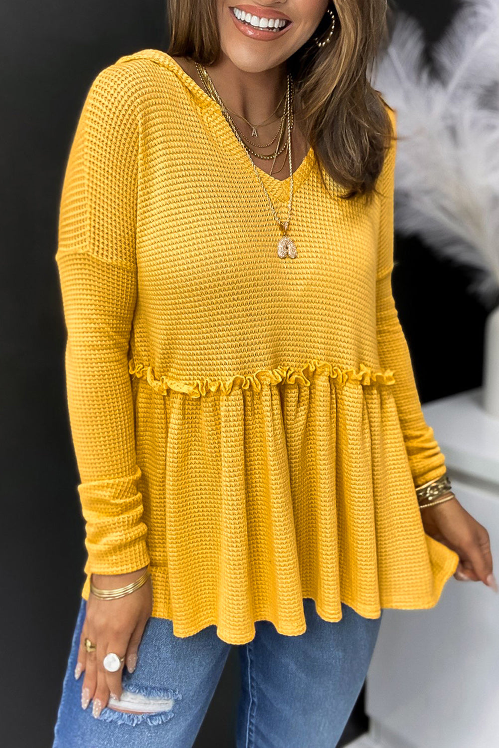 A stylish yellow V neck drop shoulder hooded top with frill detail, showcasing a relaxed fit and long sleeves, perfect for casual wear.