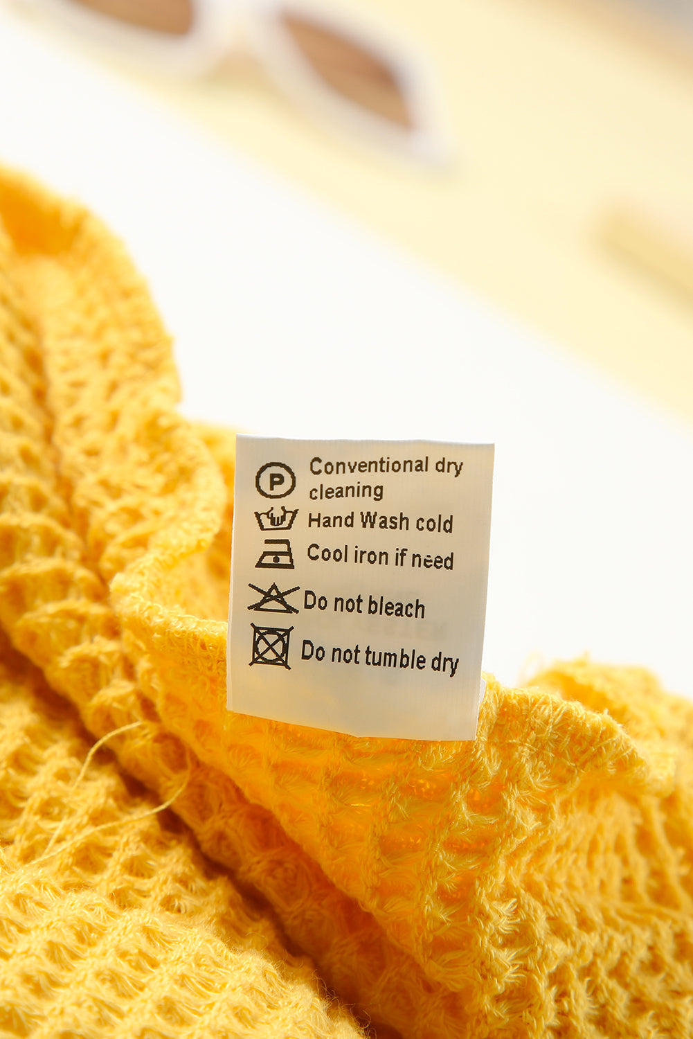 A stylish yellow V neck drop shoulder hooded top with frill detail, showcasing a relaxed fit and long sleeves, perfect for casual wear.