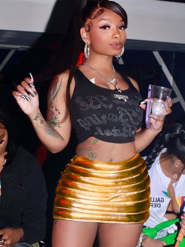 A stylish gold women's puffer skirt featuring a metallic shiny finish, quilted design, and a mini A-line silhouette, perfect for various occasions.