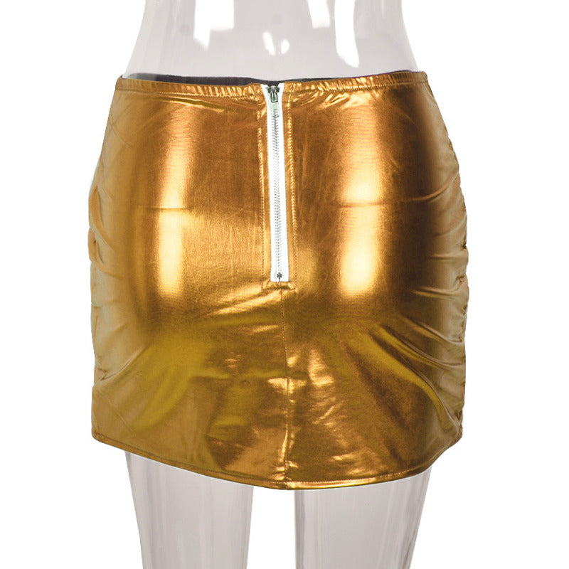 A stylish gold women's puffer skirt featuring a metallic shiny finish, quilted design, and a mini A-line silhouette, perfect for various occasions.