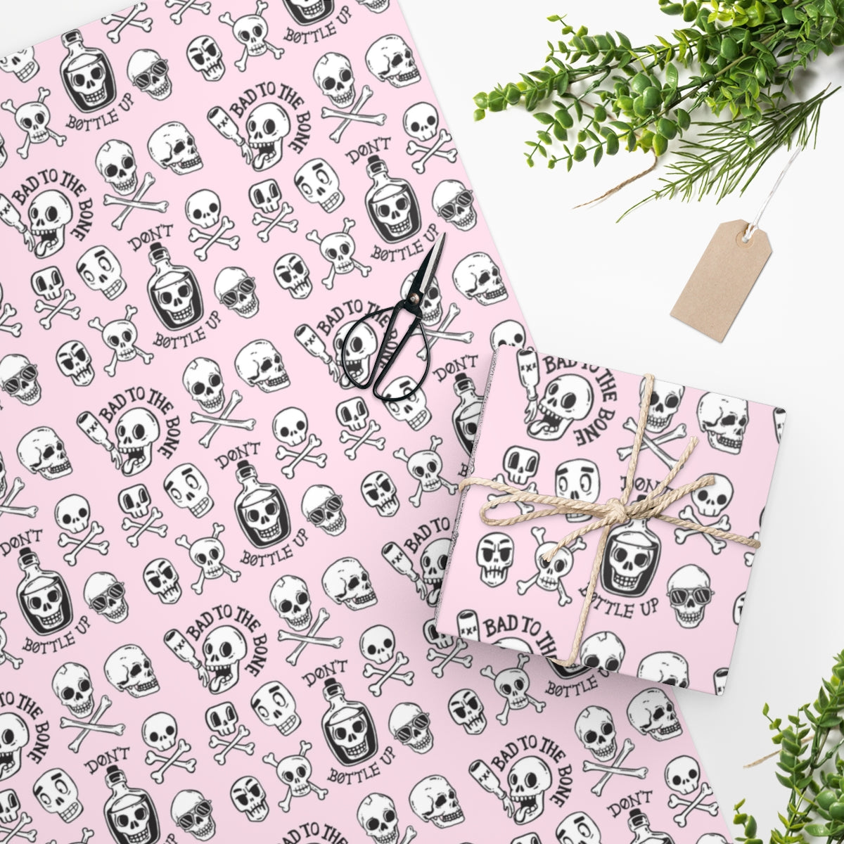 Pink Skull Wrapping Paper featuring edge-to-edge printing on premium gloss paper, rolled up for easy storage.