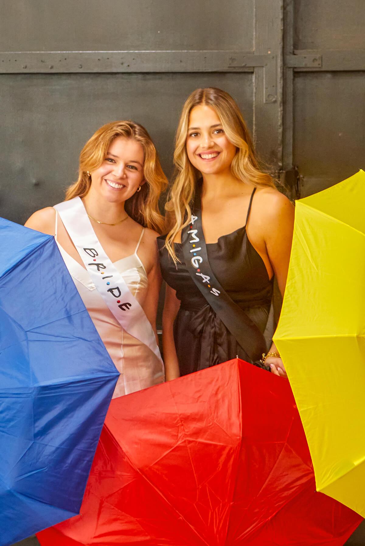A set of FRIENDS bachelorette party sashes featuring shiny leopard foil design on white satin ribbon, perfect for brides and their amigas.