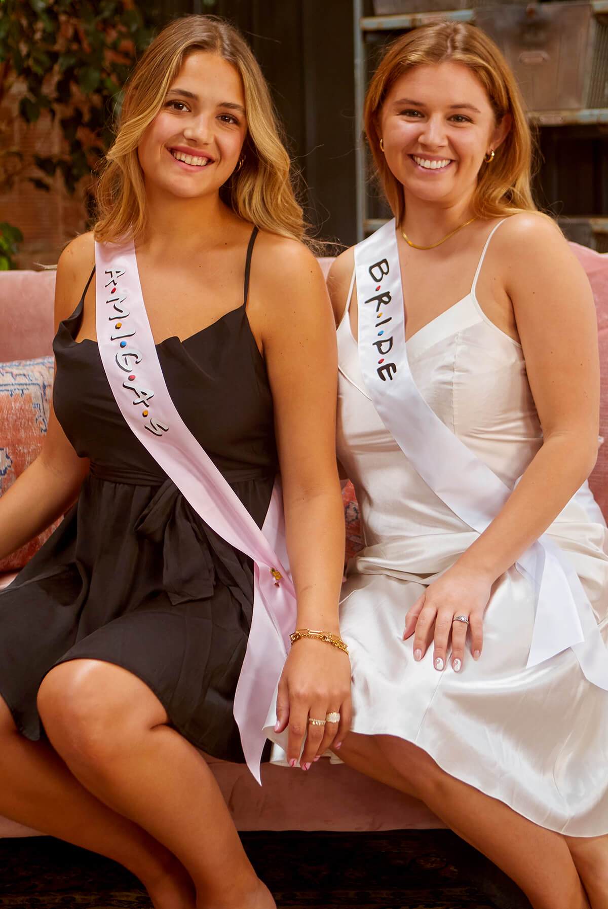 A set of FRIENDS bachelorette party sashes featuring shiny leopard foil design on white satin ribbon, perfect for brides and their amigas.