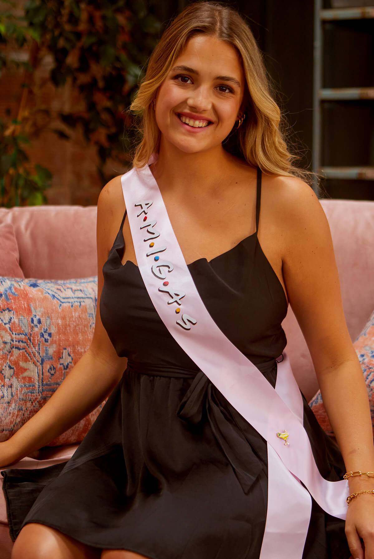 A set of FRIENDS bachelorette party sashes featuring shiny leopard foil design on white satin ribbon, perfect for brides and their amigas.