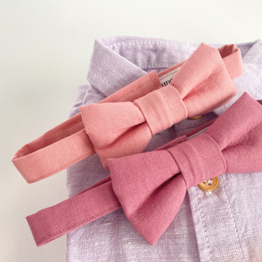 A handmade pale pink boys bow tie with a velcro fastening, perfect for weddings and special occasions, displayed on a white background.