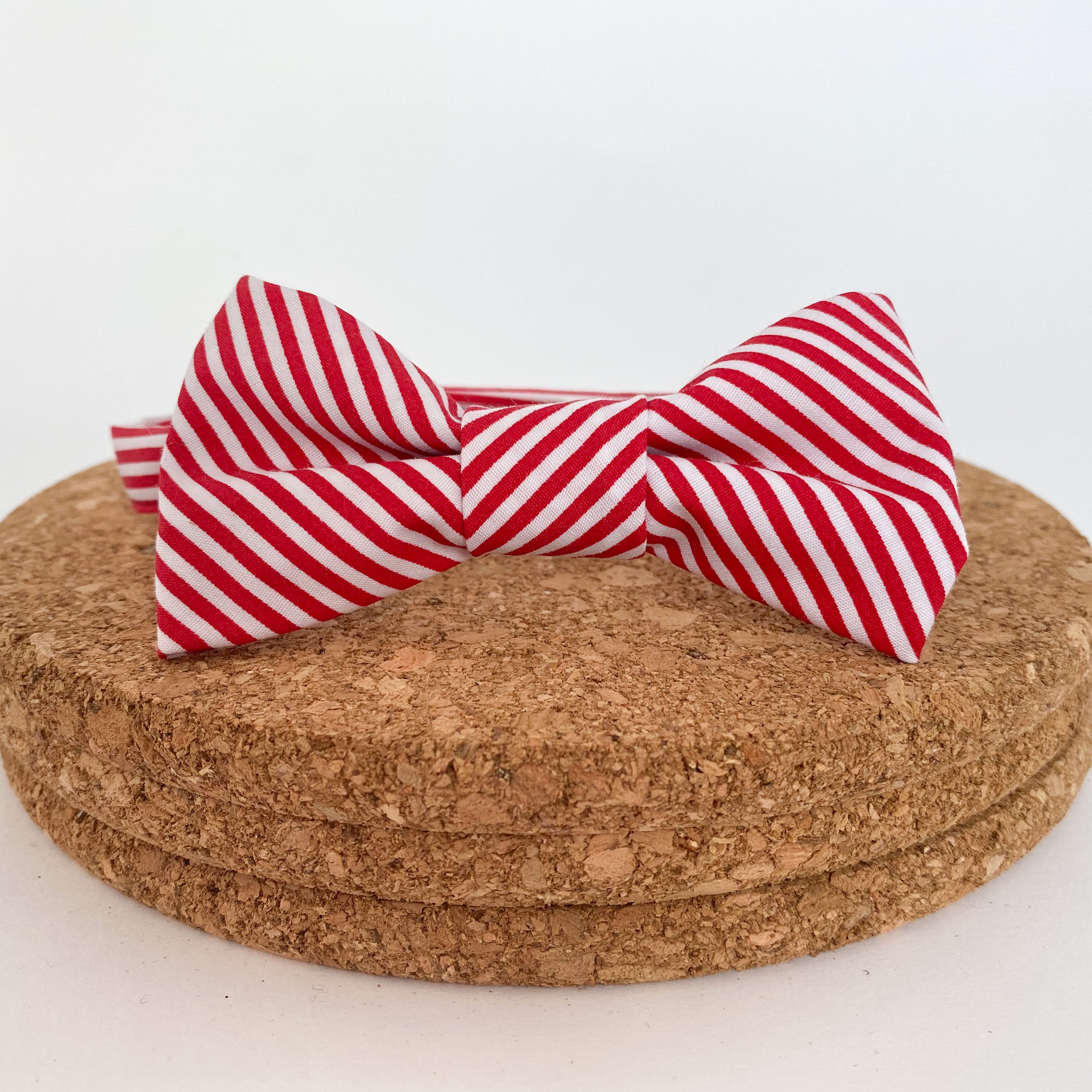 TOMMY Boys Bow Tie in bright red and white stripes, handmade in England with a velcro fastening.