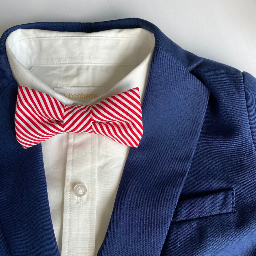 TOMMY Boys Bow Tie in bright red and white stripes, handmade in England with a velcro fastening.
